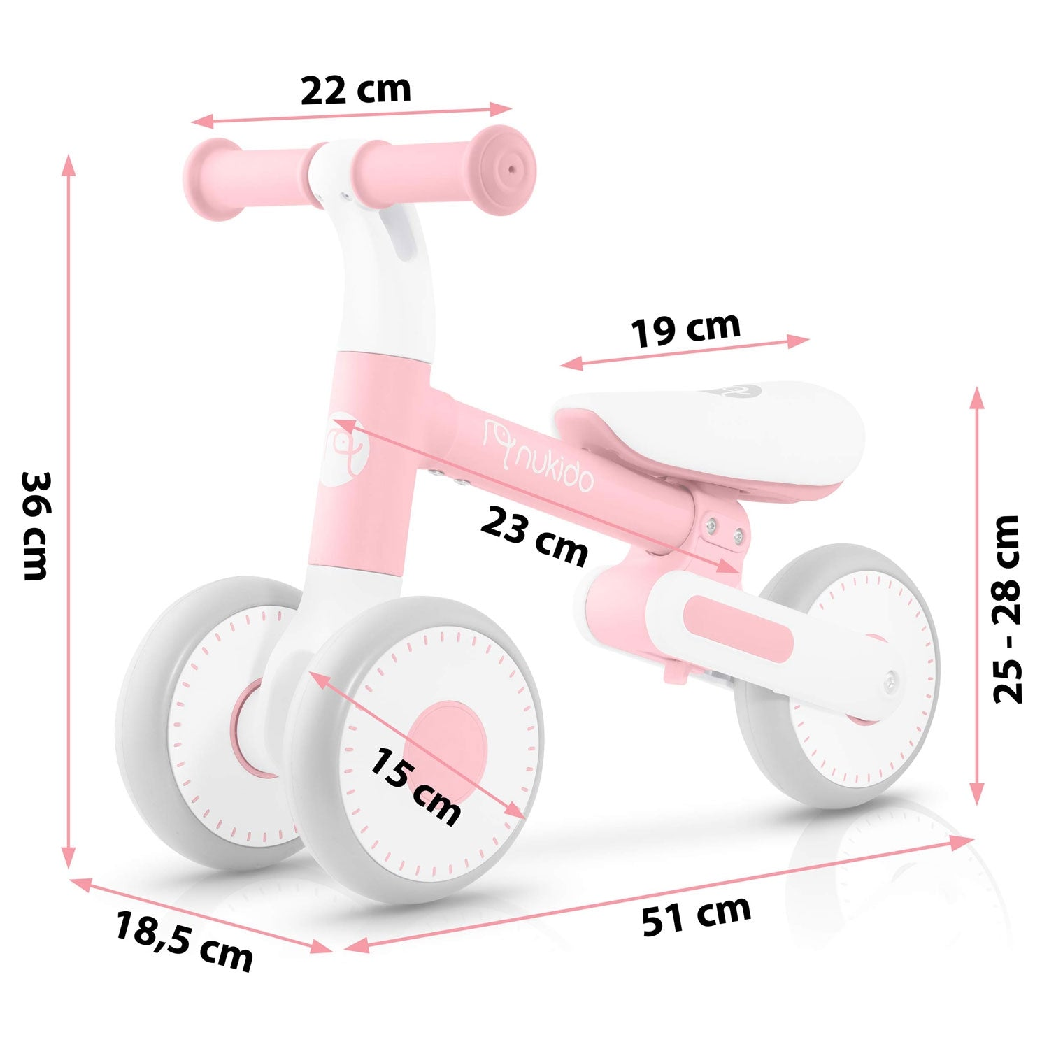 Una bicicleta de equilibrio rosa y blanca con dimensiones etiquetadas. Tiene un asiento blanco y ruedas grises. Se ve la marca 'nukido'.