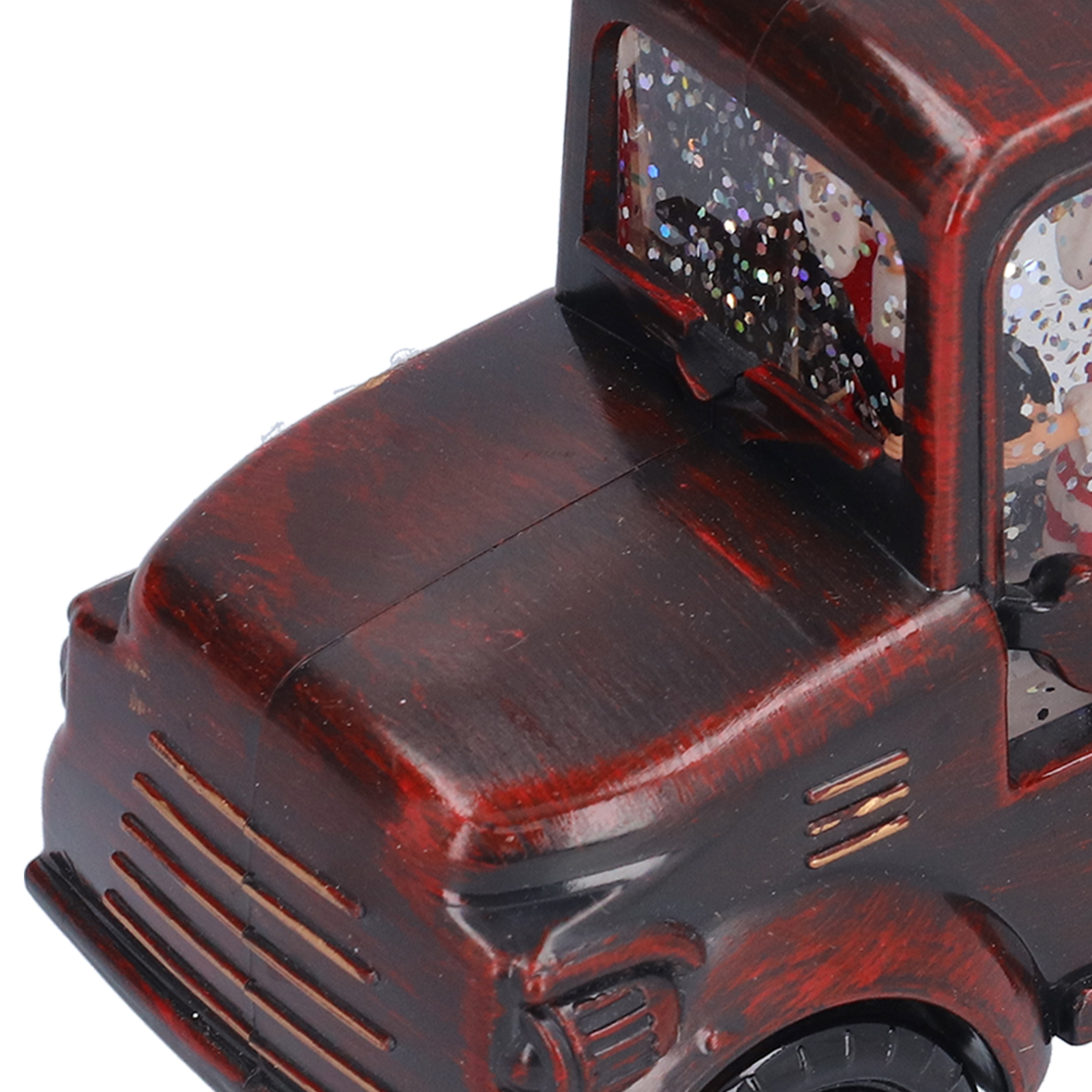 Nahaufnahme eines rot-braunen Spielzeug-Trucks. Der Truck hat ein klares Fenster, gefüllt mit Glitzer und einer Weihnachtsszene.