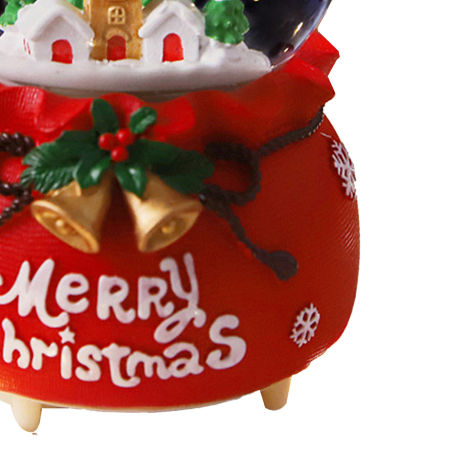 Eine Weihnachtsschneekugel mit roter Basis mit Aufschrift Frohe Weihnachten. Sie hat Glocken, ein Dorf und Schneeflocken.