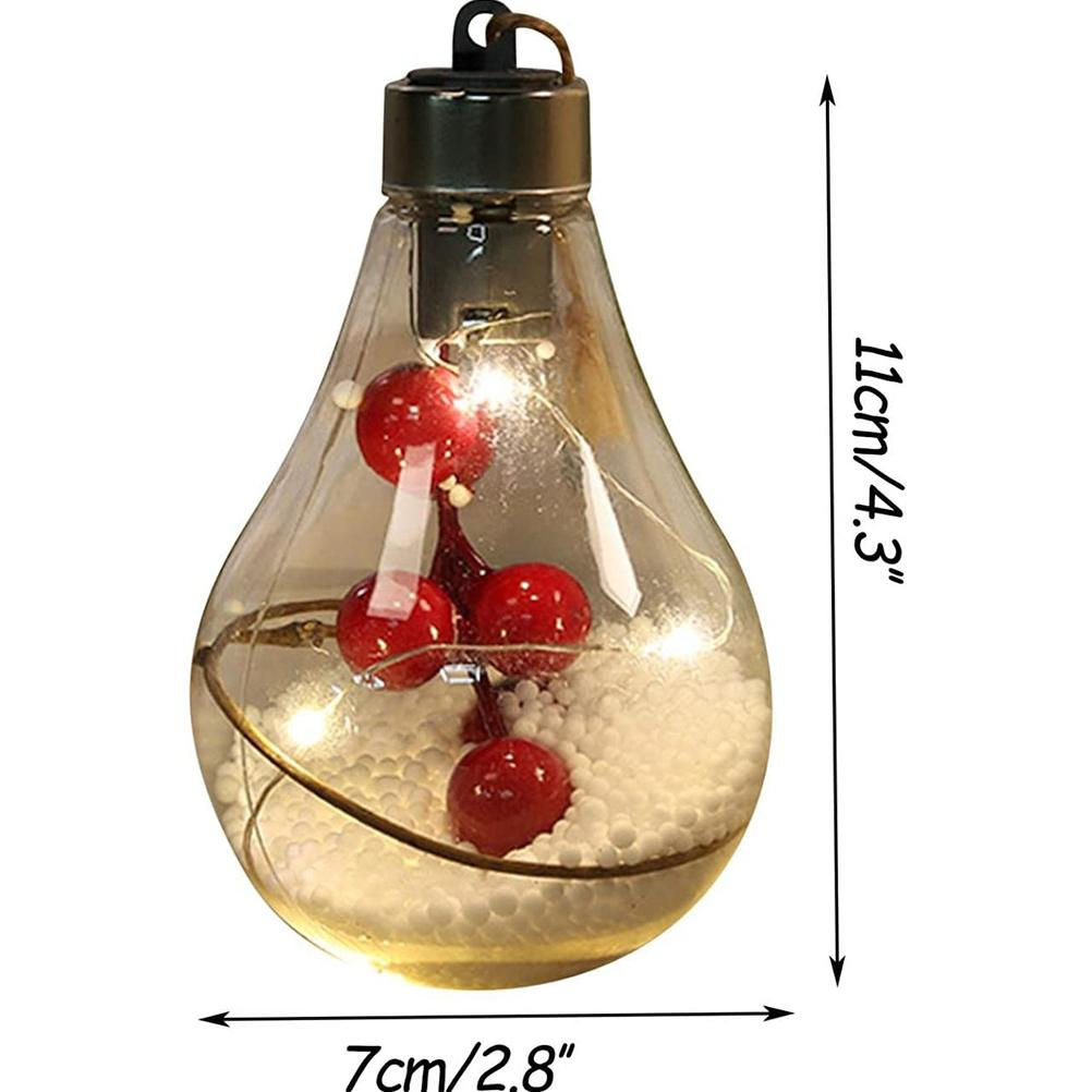 Eine durchsichtige Glühbirne mit roten Beeren, weißen Perlen und einer schwarzen Kappe. Abmessungen sind 7 cm x 11 cm.