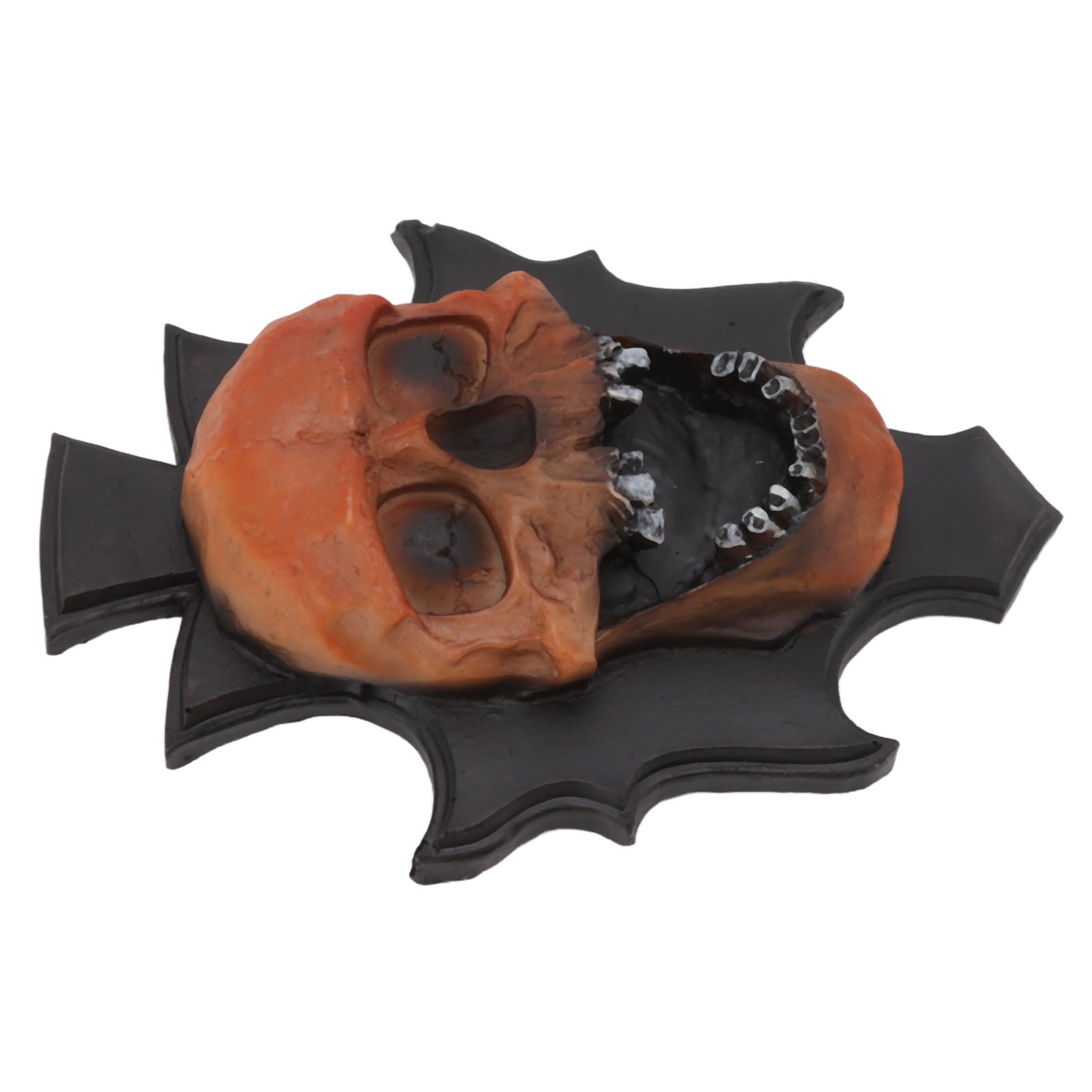 Orangefarbene Totenkopfdekoration mit offenem Mund, schwarze Basis. Der Schädel befindet sich auf einer schwarzen fledermausförmigen Basis.