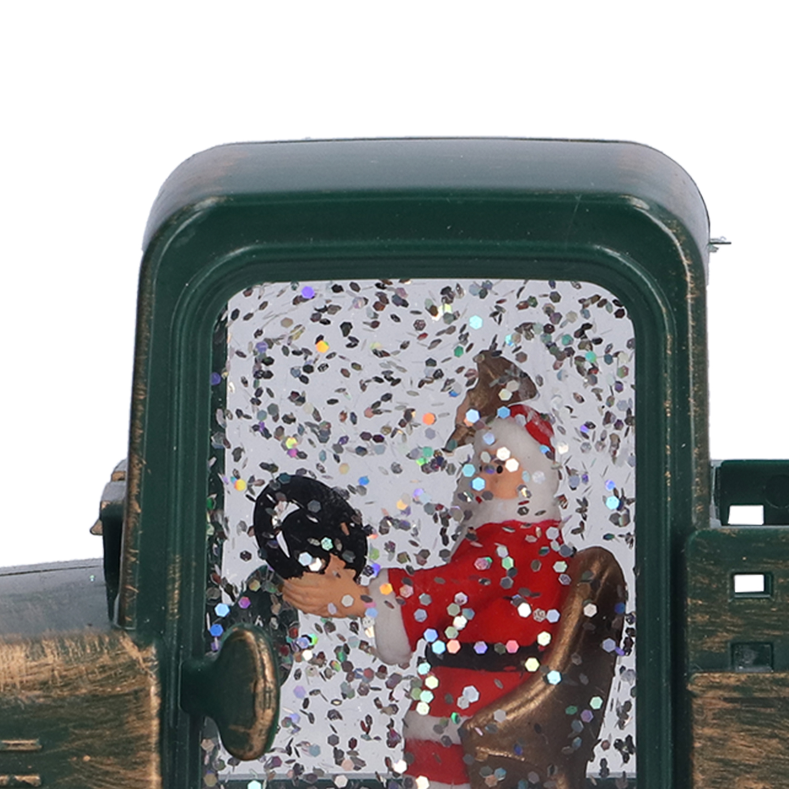 Eine Weihnachtsdekoration. Der Weihnachtsmann in rotem Anzug fährt einen grünen LKW. Es ist eine Schneekugel mit Glitzer.