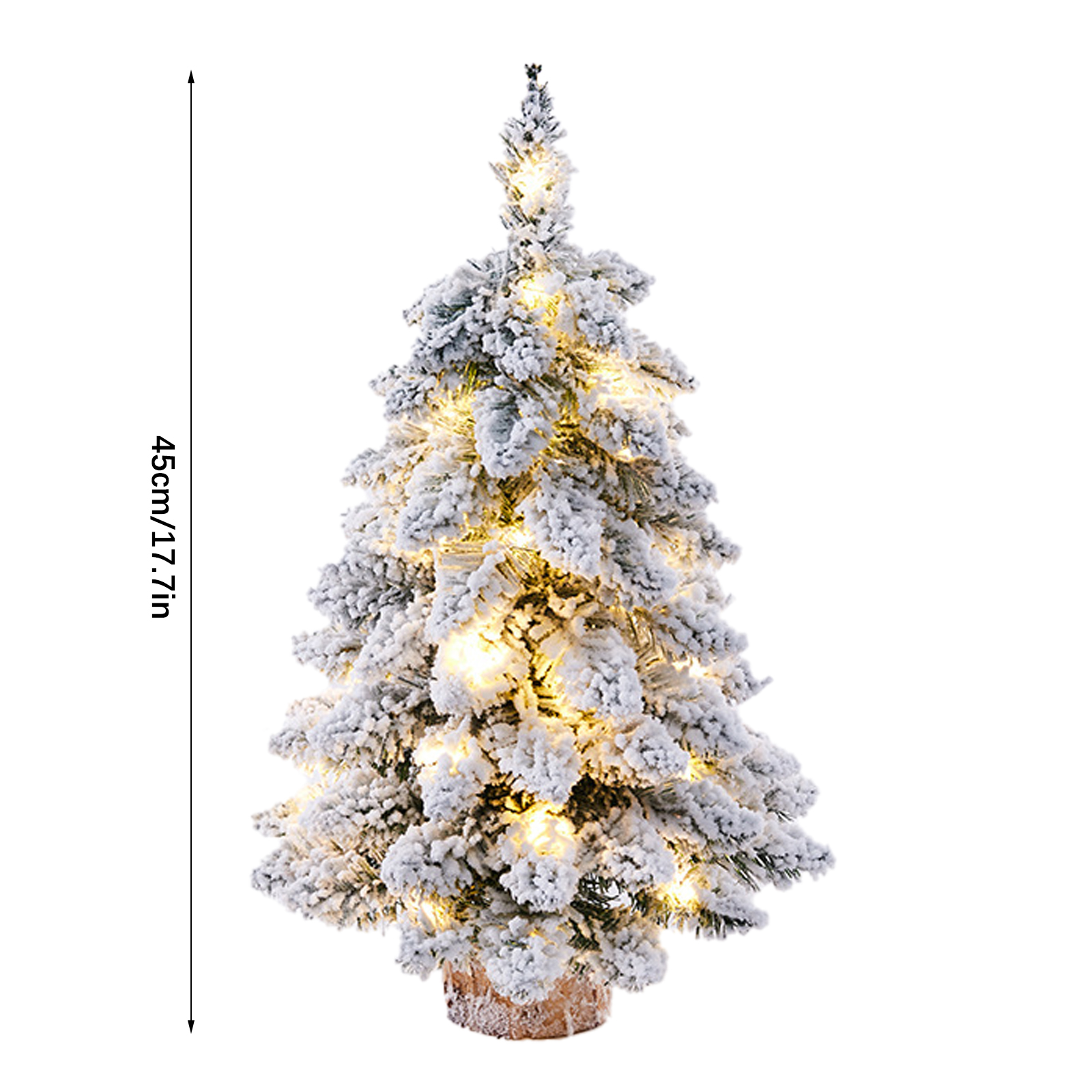 Ein kleiner künstlicher Weihnachtsbaum, bedeckt mit weißem Schnee, warmweißen Lichtern und einem Holzsockel.