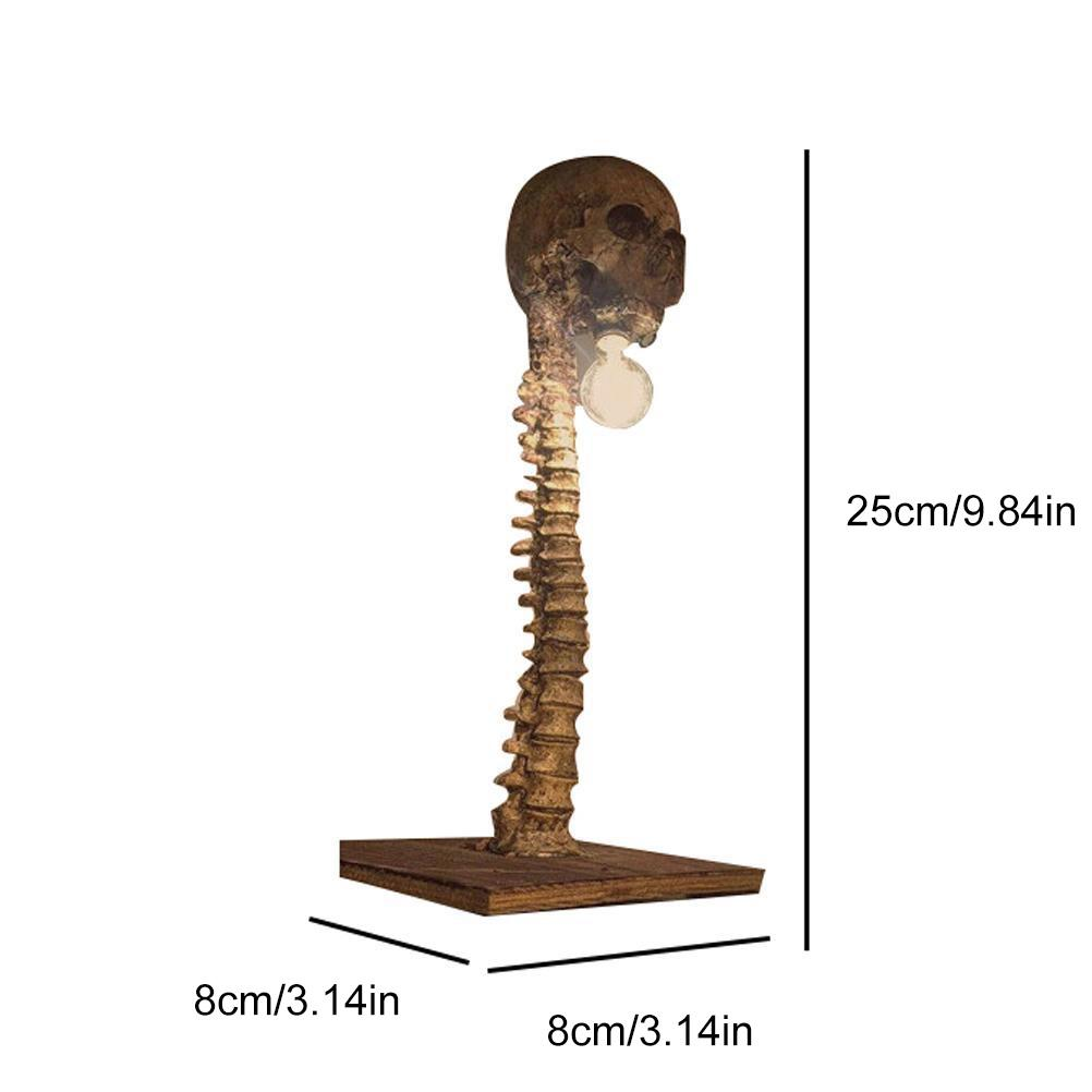 Ein dekoratives Modell eines menschlichen Schädels und einer Wirbelsäule, braun, mit Holzsockel. Maße in cm und Zoll angegeben.