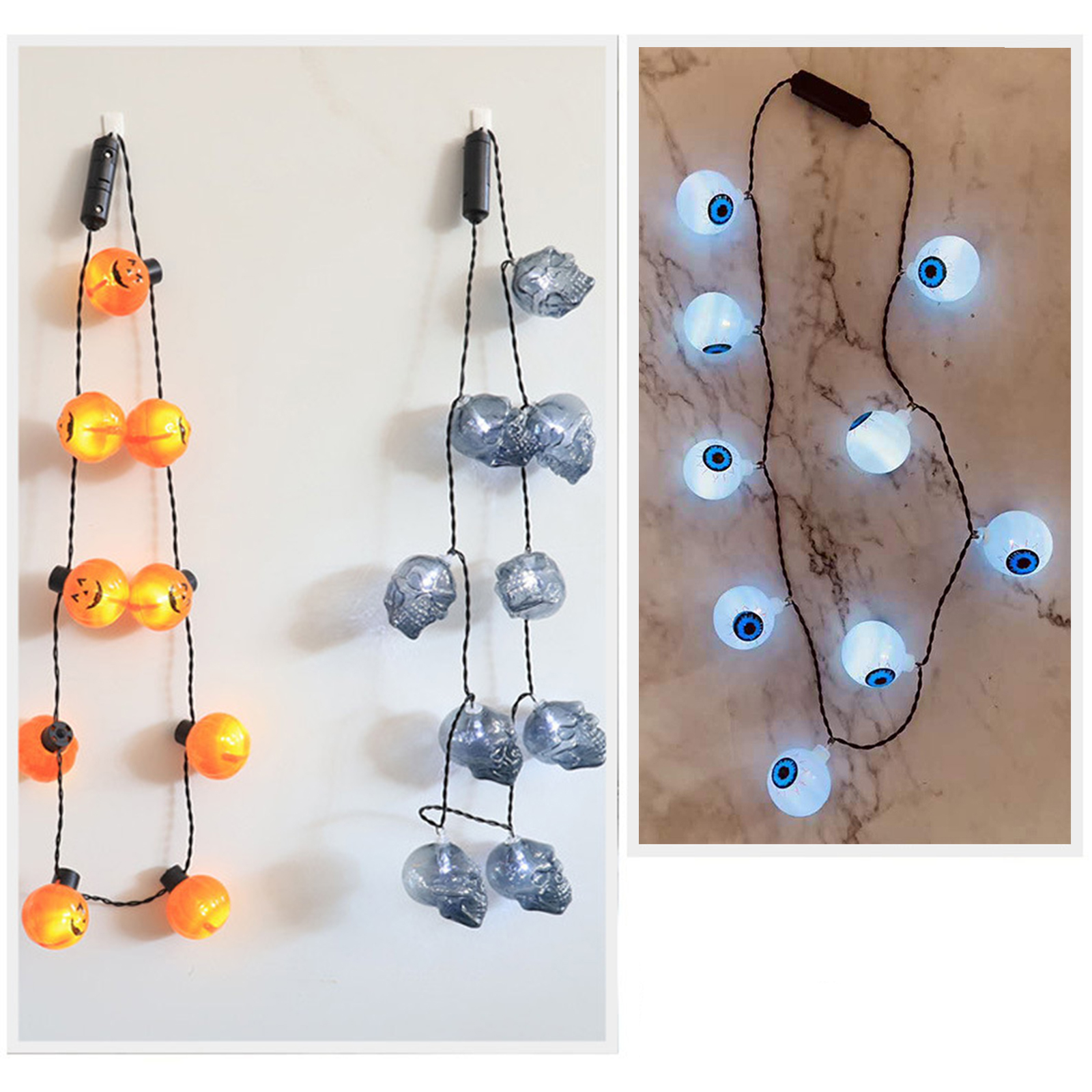 Das Bild zeigt Halloween-Lichter: Kürbis-, Schädel- und Augapfel-förmige Lichter. Sie hängen an schwarzen Drähten.