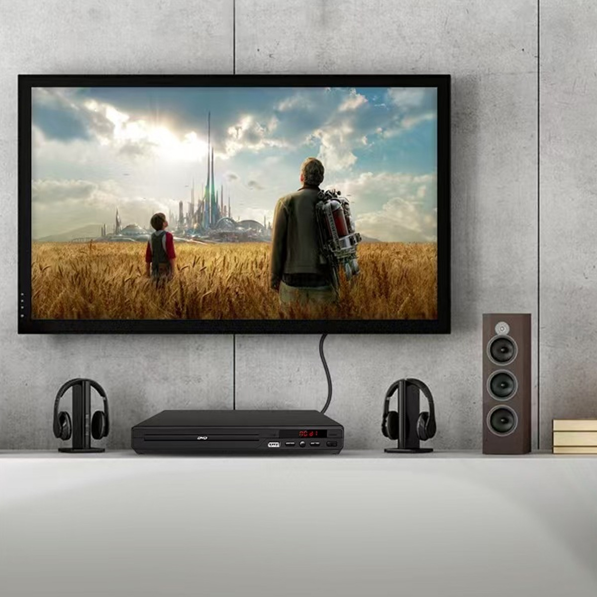 Der Fernseher zeigt eine Szene mit zwei Figuren in einem Weizenfeld, die eine futuristische Stadt betrachten. Kopfhörer, DVD-Player und Lautsprecher sind davor.