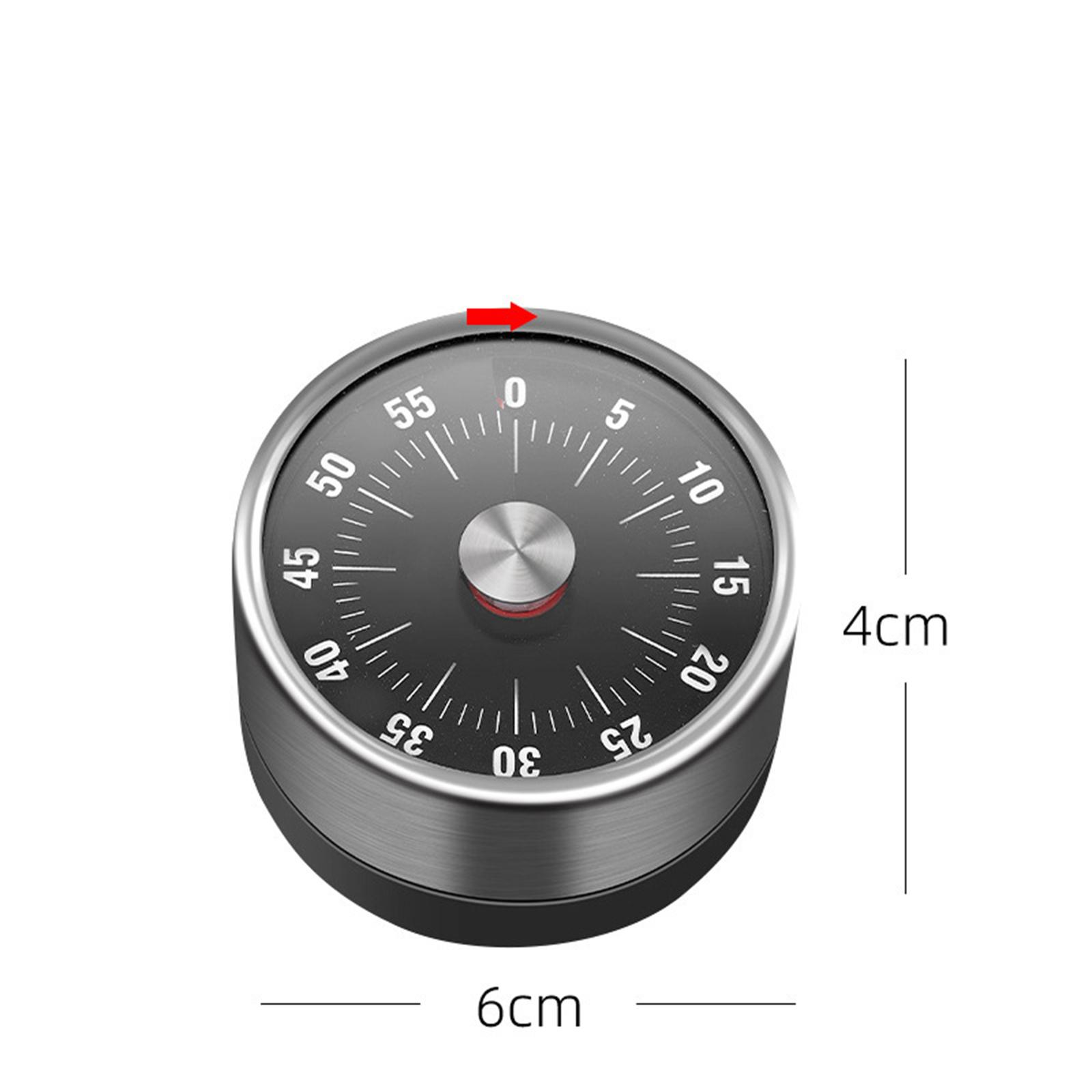 Ein runder Timer mit schwarzem Zifferblatt. Die Zahlen und Striche sind weiß. Ein Pfeil zeigt auf die 0. Abmessungen sind 6cm x 4cm.