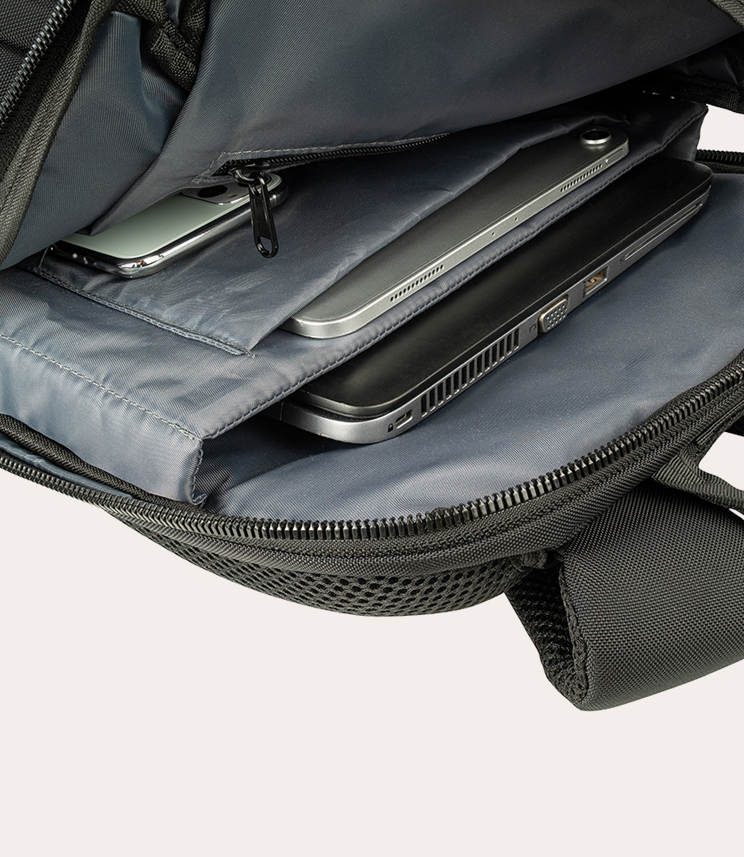 In einem schwarzen Rucksack sind ein Smartphone, ein Tablet und ein Laptop zu sehen. Die Tasche ist geöffnet, die Geräte sind sichtbar.