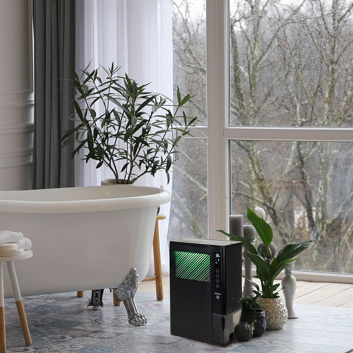 Escena de baño con bañera con patas de garra, una planta y un purificador de aire negro. Ventana muestra vista lluviosa exterior.