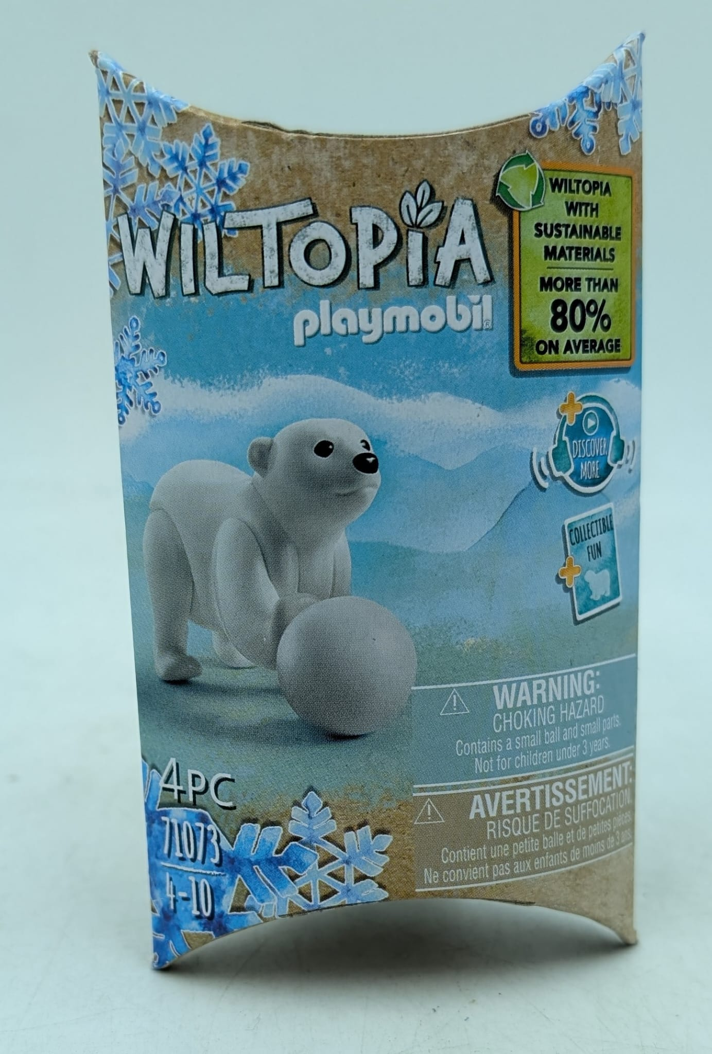 A Playmobil box with a polar bear toy holding a ball. The box is labeled 'Wiltopia' and mentions sustainable materials.