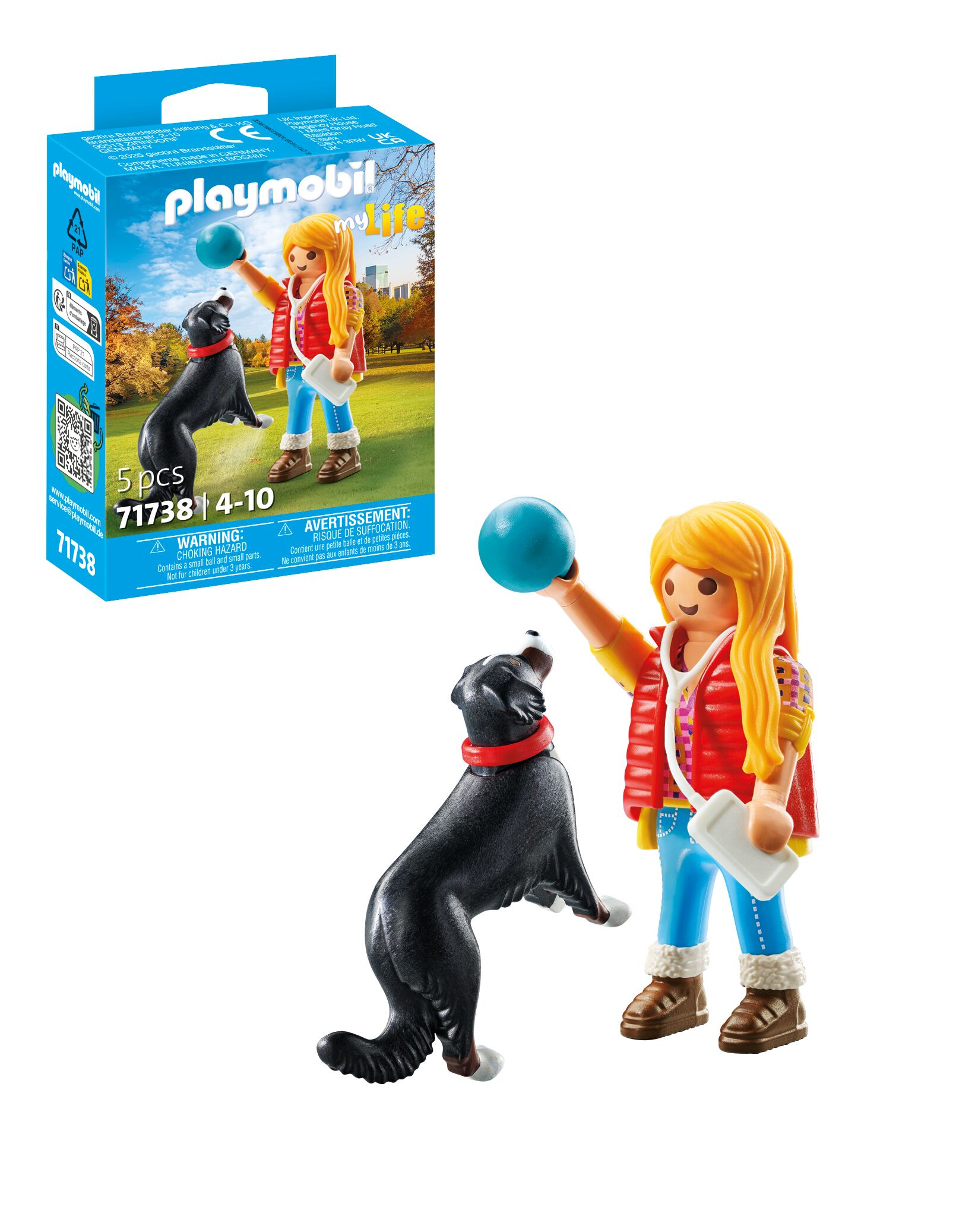 Figurka Playmobil z blond dziewczynką i czarnym psem z czerwoną obrożą bawiącymi się piłką.