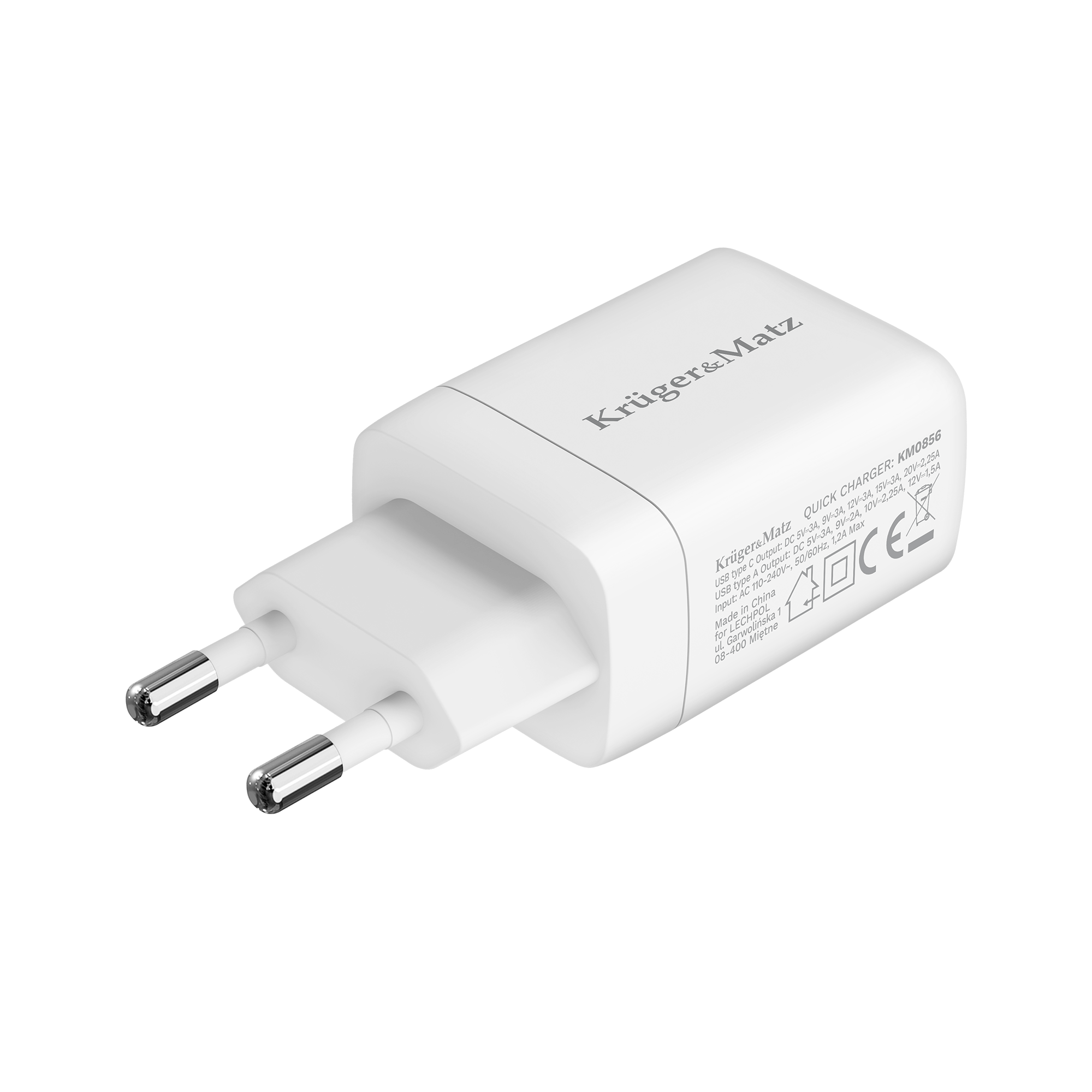 Biała szybka ładowarka Krüger&Matz z dwoma srebrnymi bolcami. Ładowarka ma tekst.