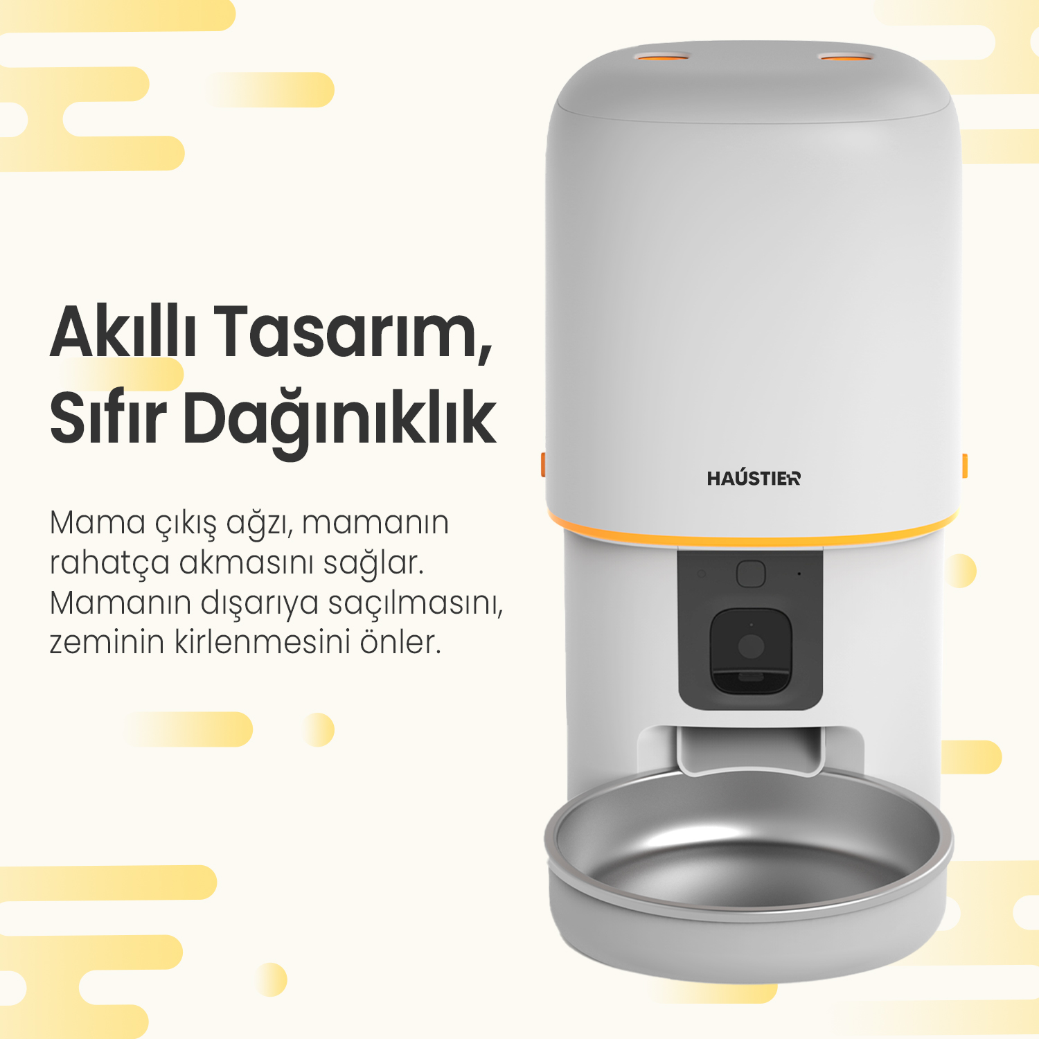 Turuncu detaylara ve paslanmaz çelik bir kaseye sahip beyaz ve gri bir evcil hayvan maması dağıtıcısı. Türkçe metin de görülebilir.