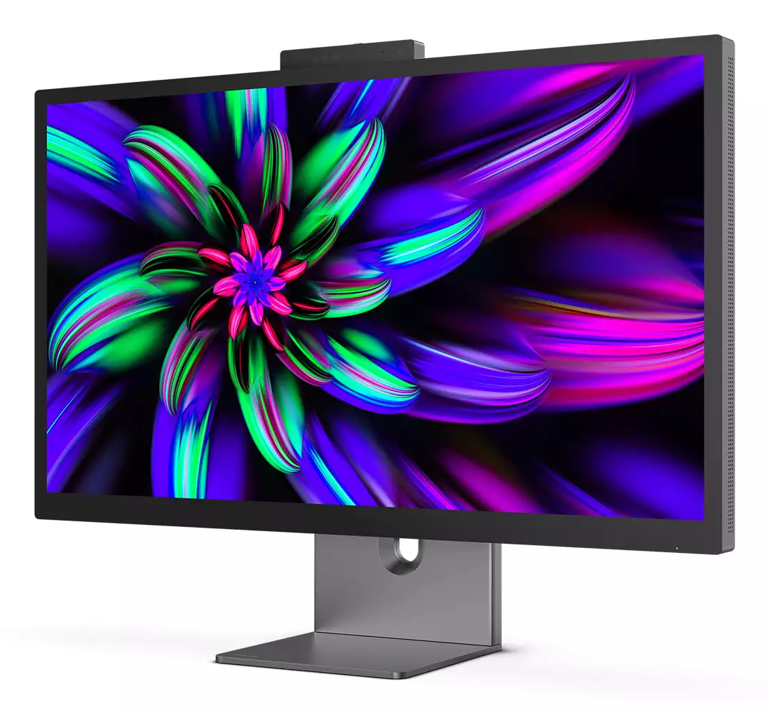 Monitor komputera wyświetla kolorowy, abstrakcyjny wzór kwiatowy. Monitor stoi na szarej podstawie. Kamera internetowa znajduje się na górze ekranu.