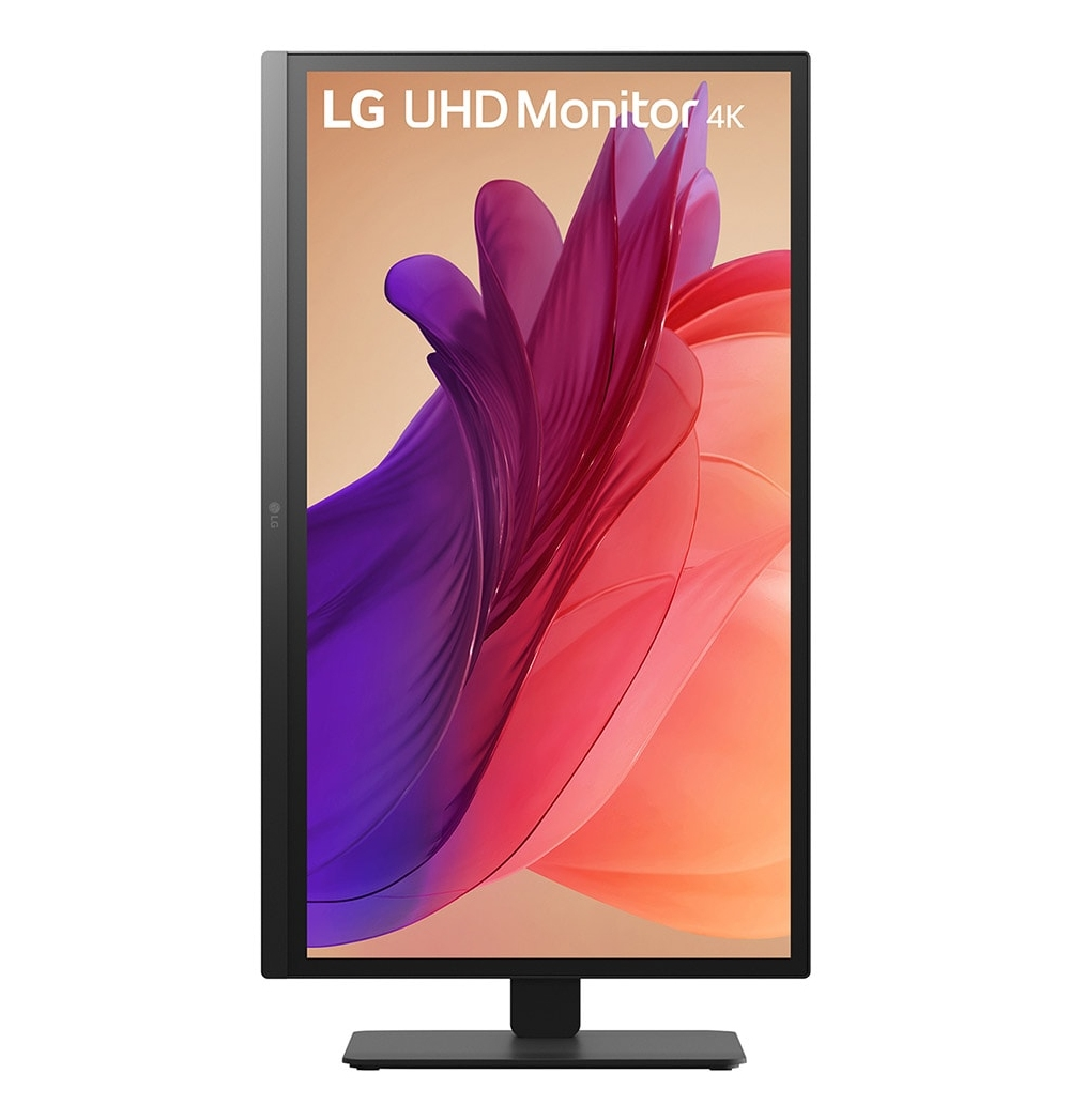 LG UHD 4K monitor displays an abstract image with purple and red hues. The monitor is black and sits on a black stand.