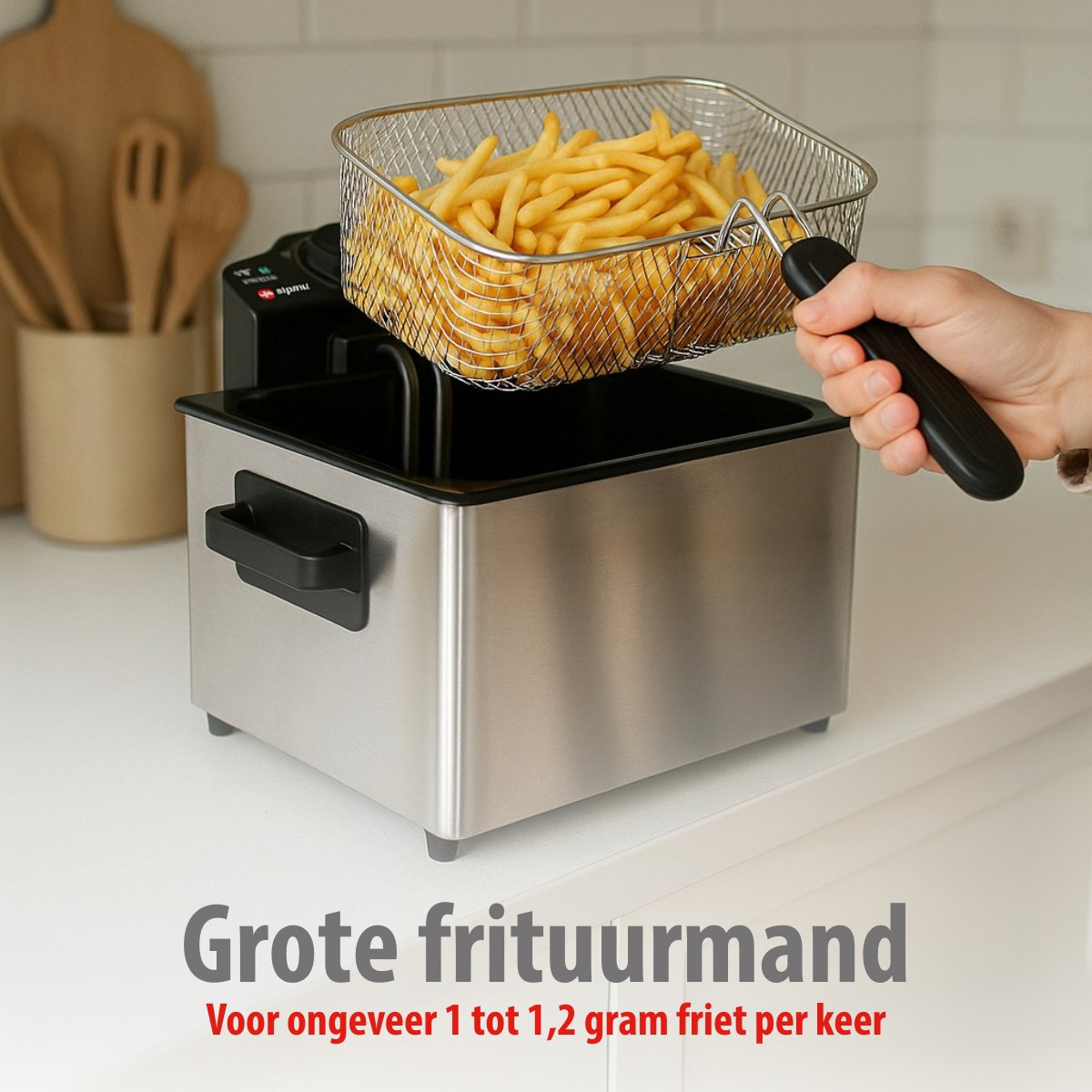 A stainless steel fryer with a basket of fries. A hand holds the basket. Text in Dutch: Large frying basket.
