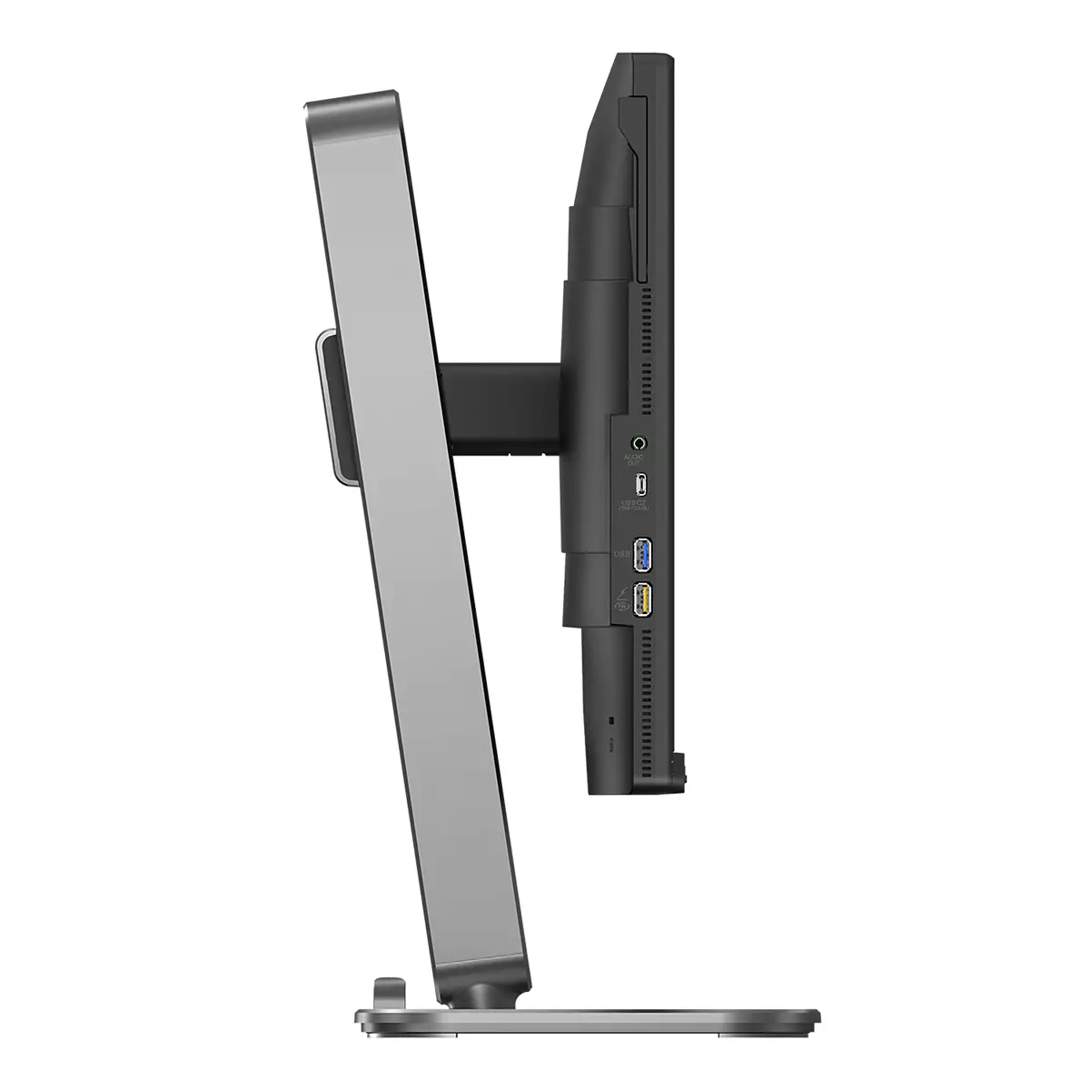 Widok z boku monitora komputerowego ze srebrną podstawą. Monitor jest czarny z widocznymi portami i połączeniami. Podstawa jest srebrna.