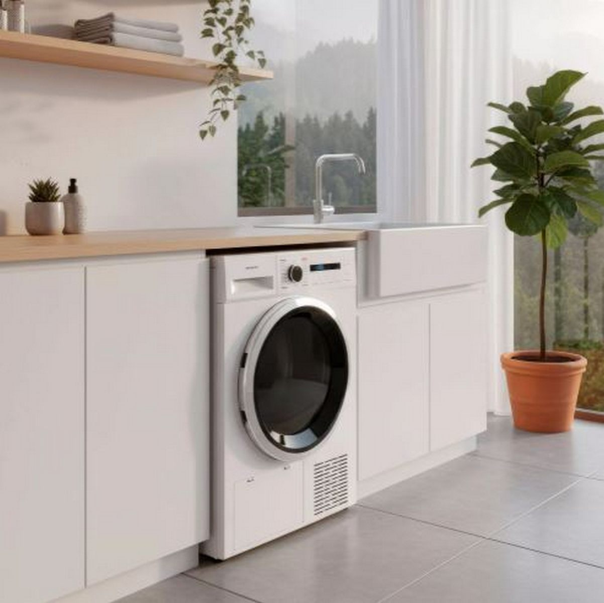 Un lavadero moderno con lavadora, fregadero y planta en maceta. Una ventana da a un bosque.