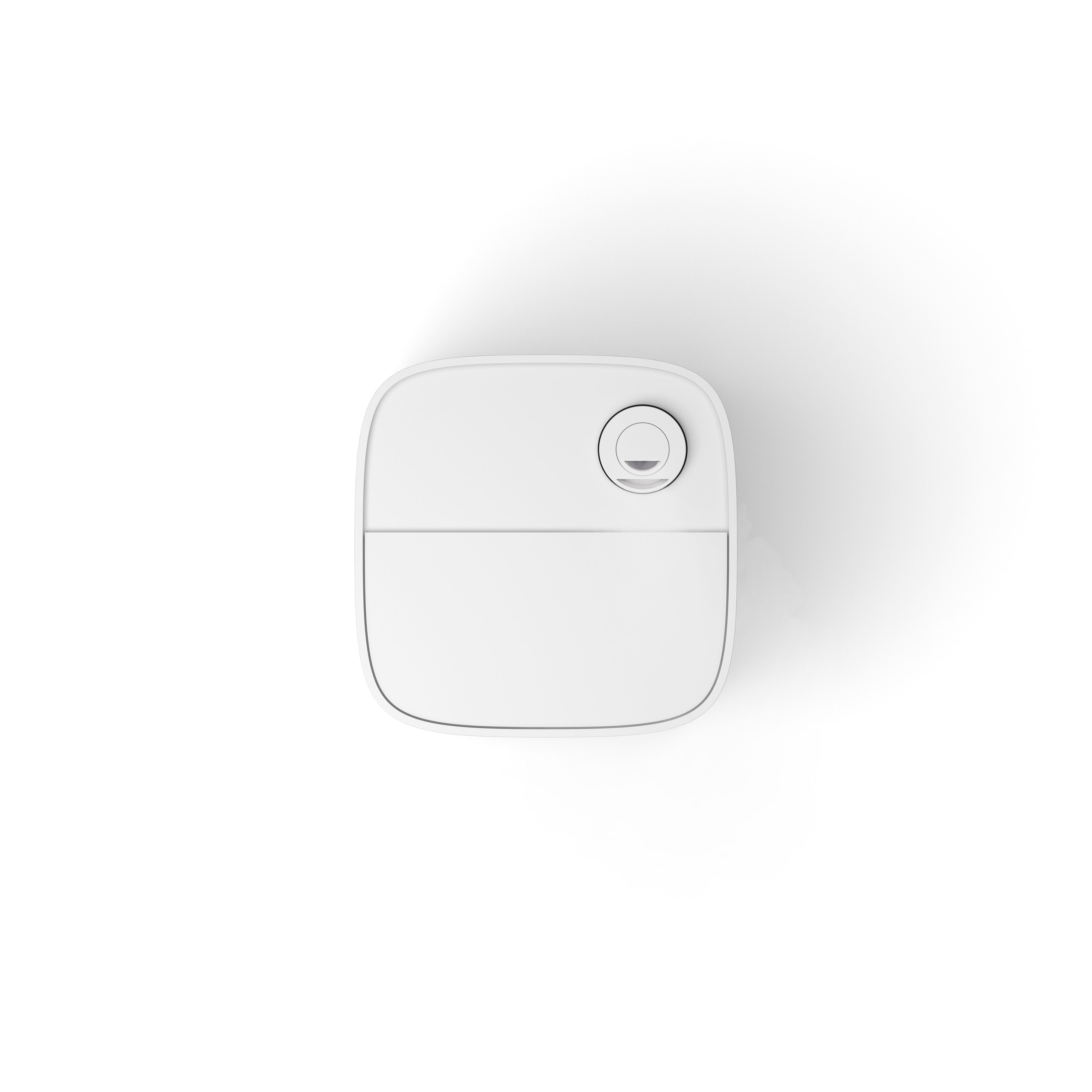 Overhead view of a white, rounded square object with a circular detail on top, set against a white background.