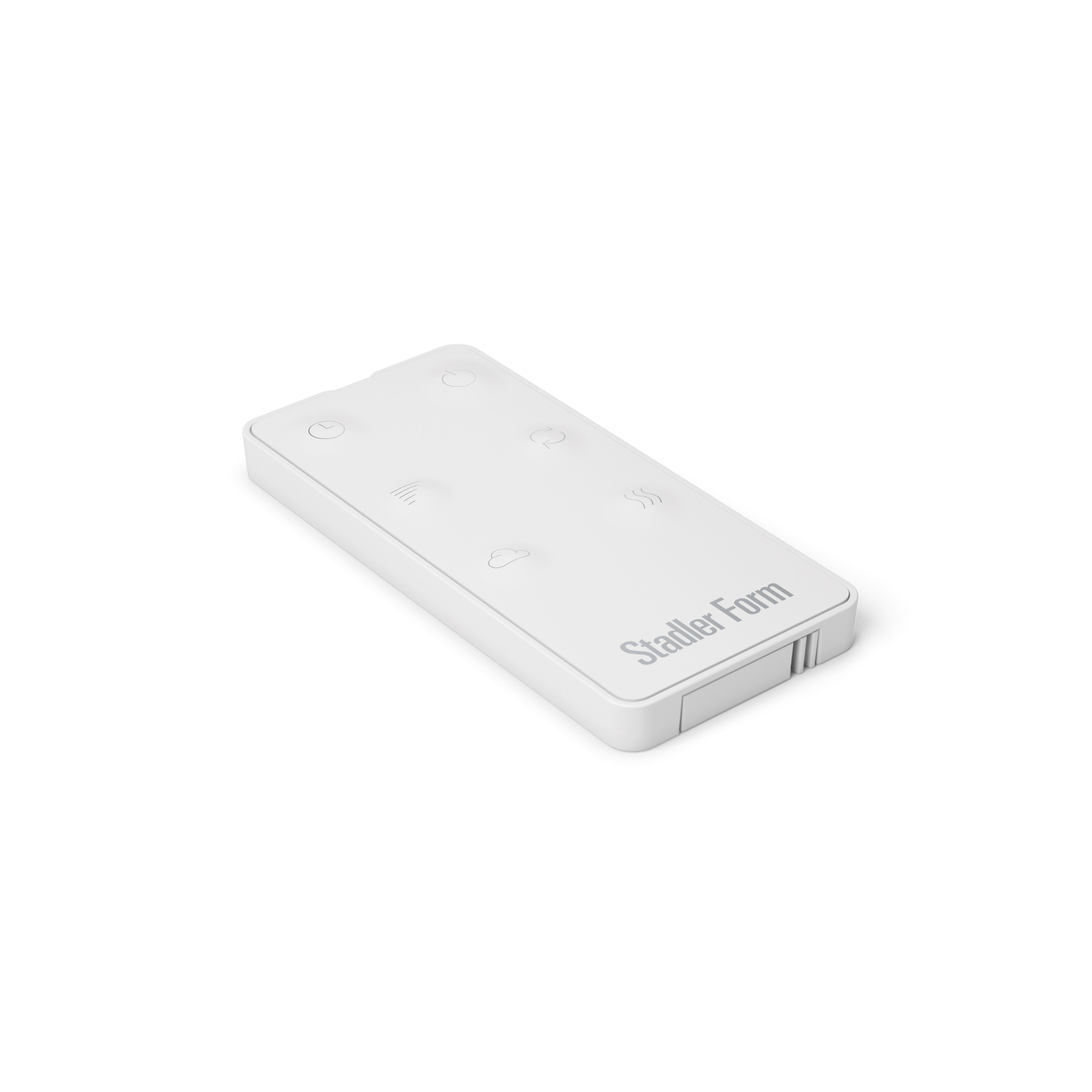 A white Stadler Form remote control lies on a white background. It has several symbols and the brand name on it.