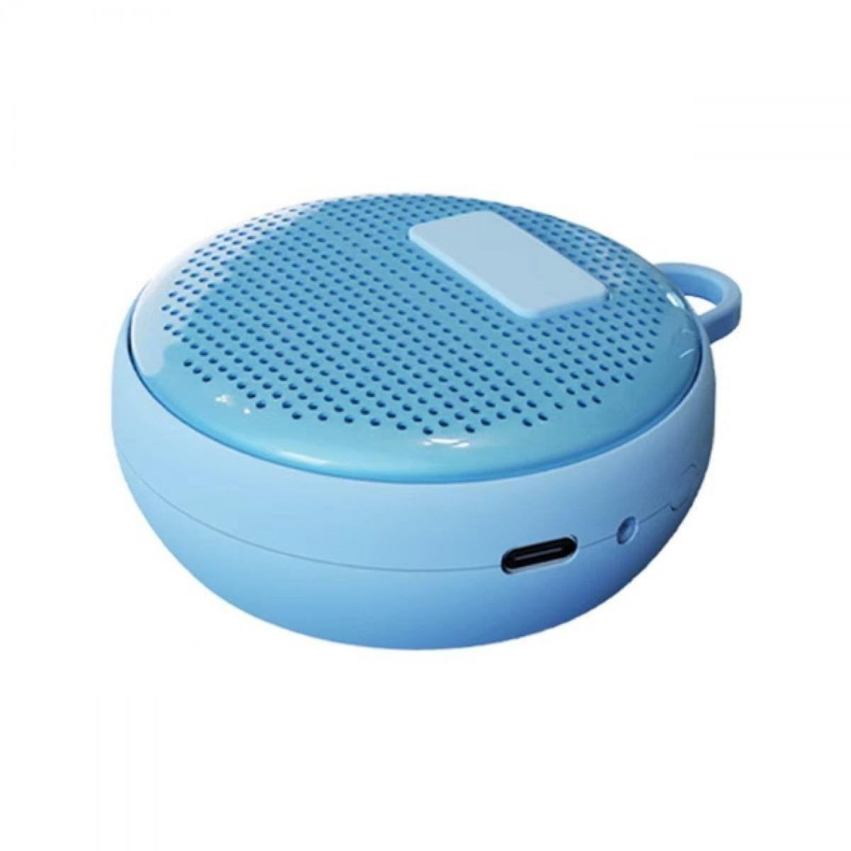 Ein kleiner, hellblauer, runder Lautsprecher mit perforierter Oberseite, Griff und USB-Anschluss auf weißem Hintergrund.