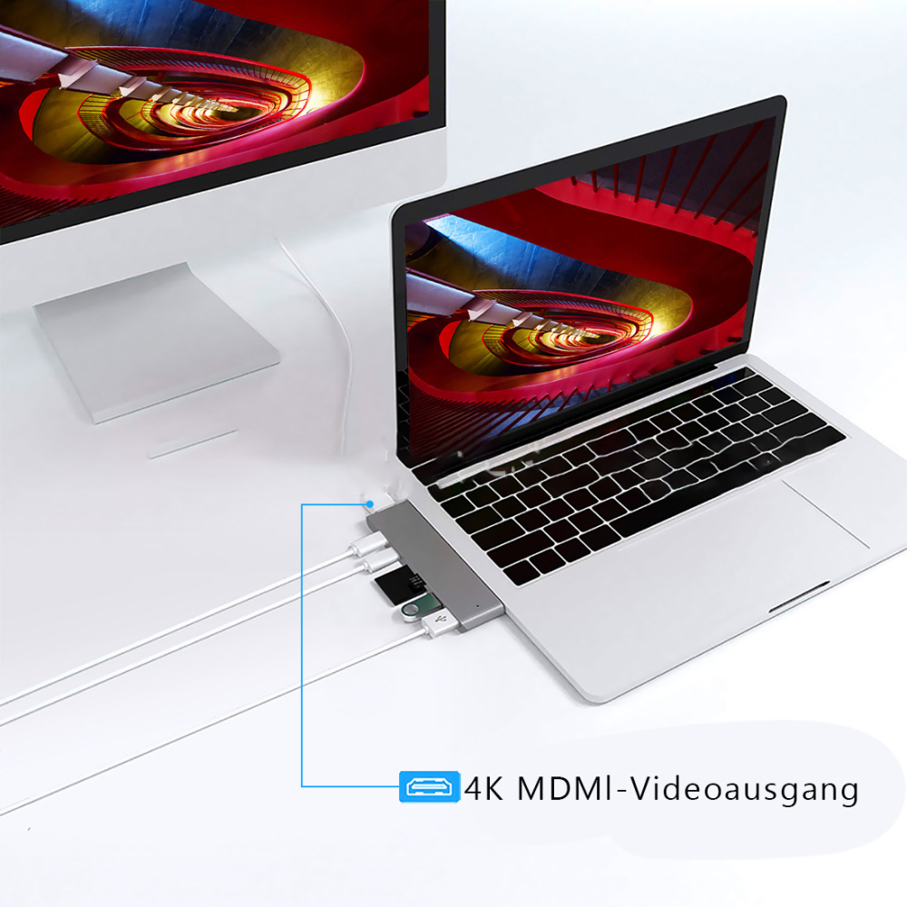 Ein Laptop, der mit einem Monitor und einem USB-Hub verbunden ist. Die Bildschirme zeigen ein abstraktes Design. Ein Kabel ist mit dem Hub verbunden.