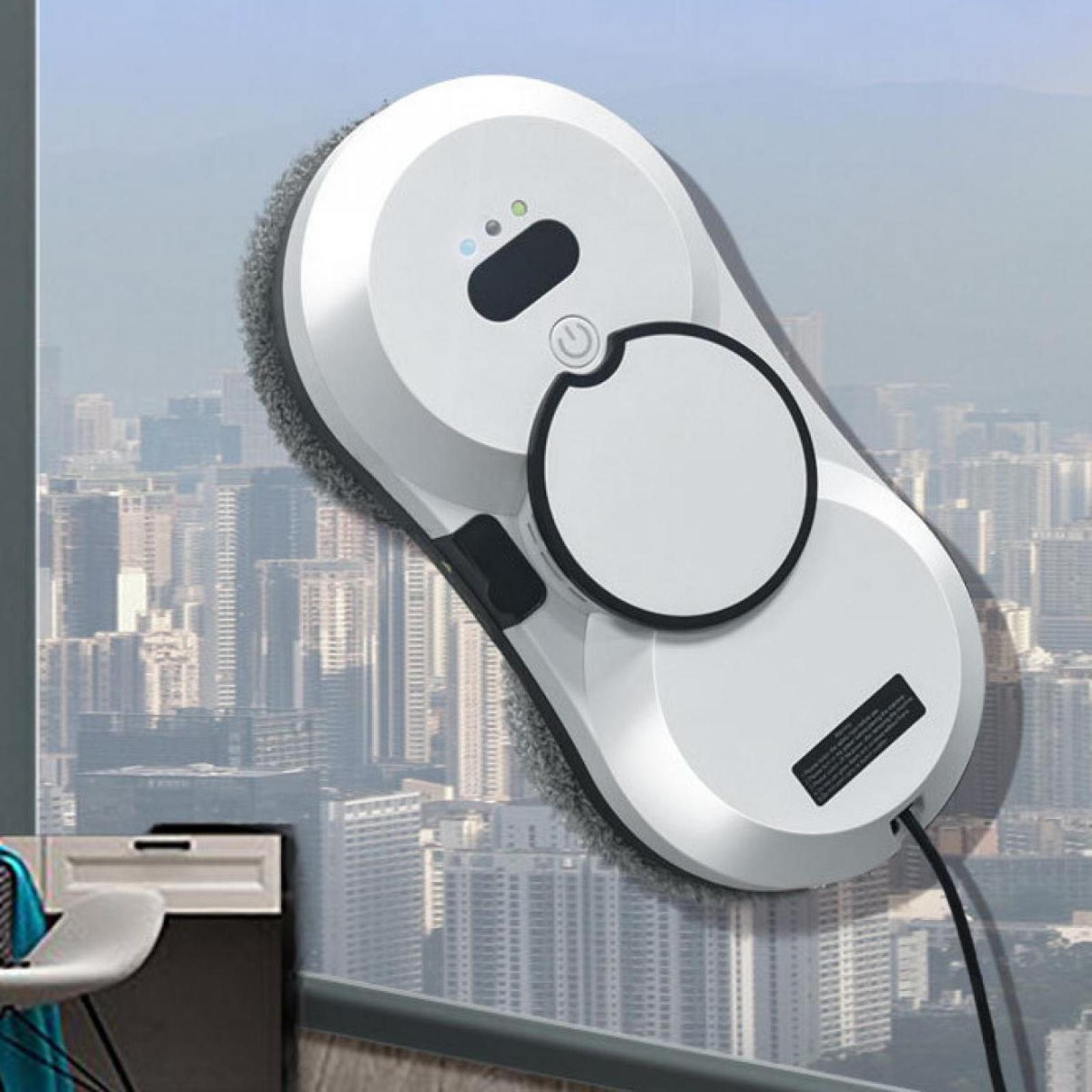 Ein weißer Fensterreinigungsroboter ist an einem Fenster mit Blick auf die Stadt im Hintergrund befestigt.