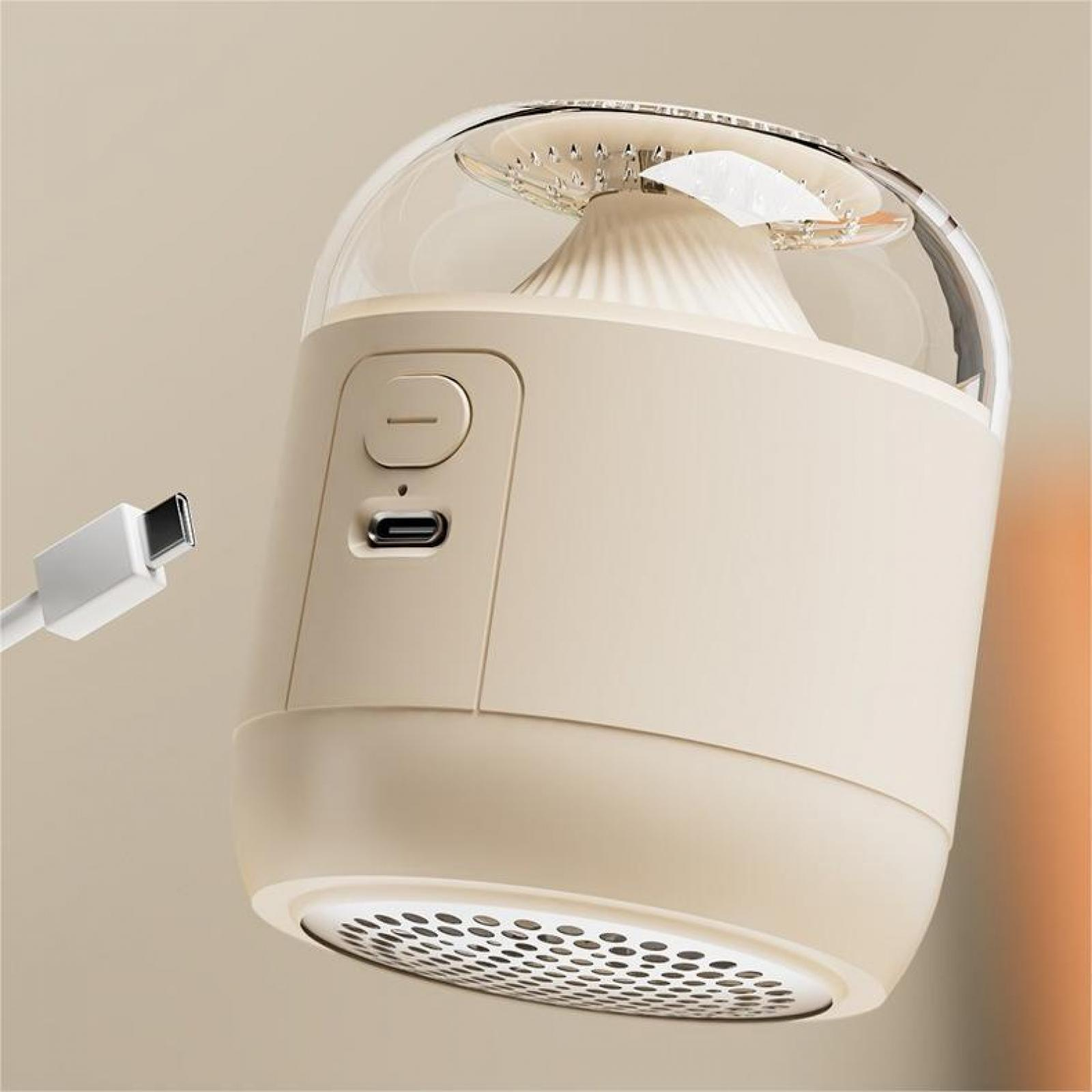 Cremefarbener Fusselentferner mit klarer Kuppel, USB-C-Anschluss und weißem Ladekabel. Der Hintergrund ist ein neutrales Beige.