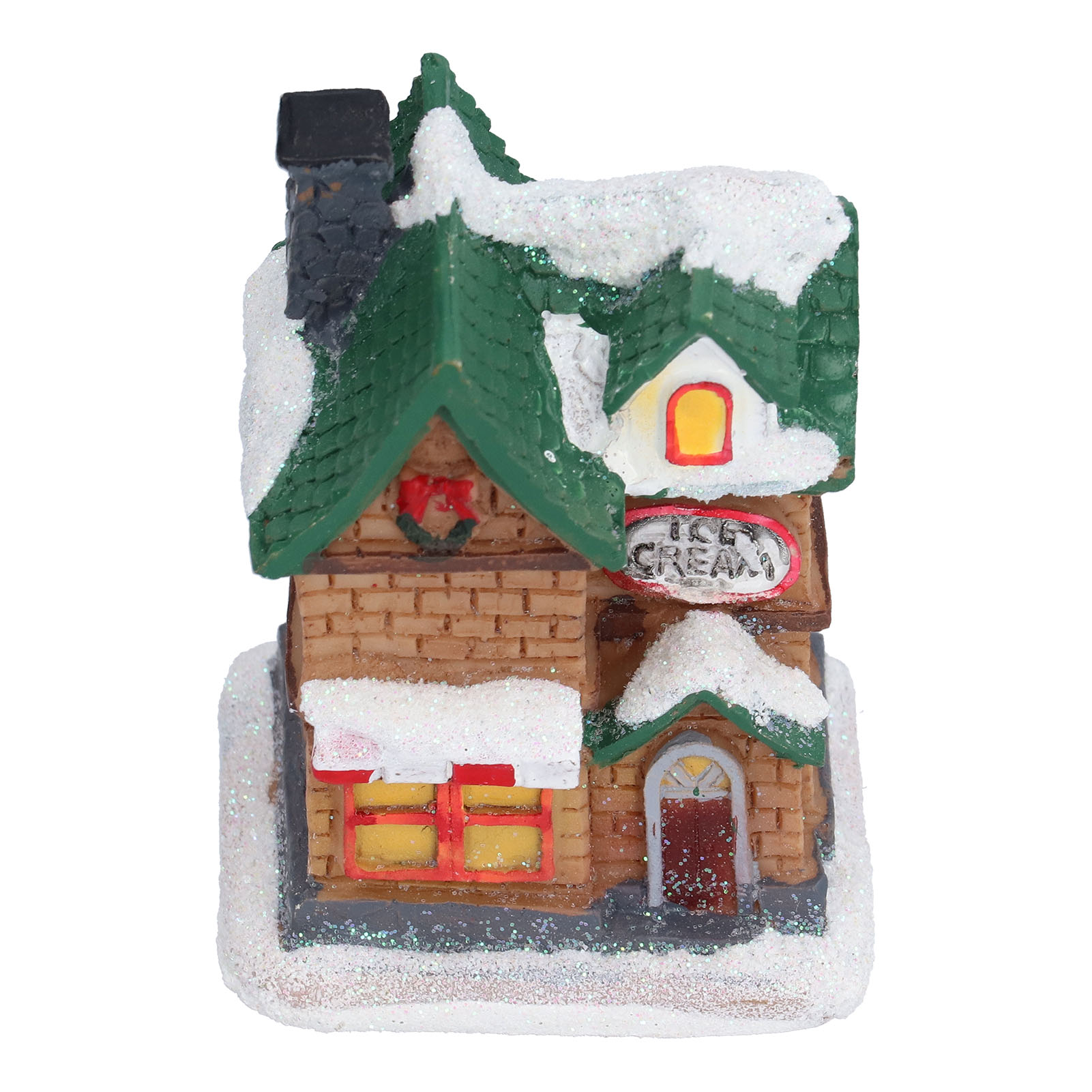 Ein Miniatur-Eiscremeladen mit einem grünen, schneebedeckten Dach. Er hat einen Schornstein, Fenster und eine Tür.