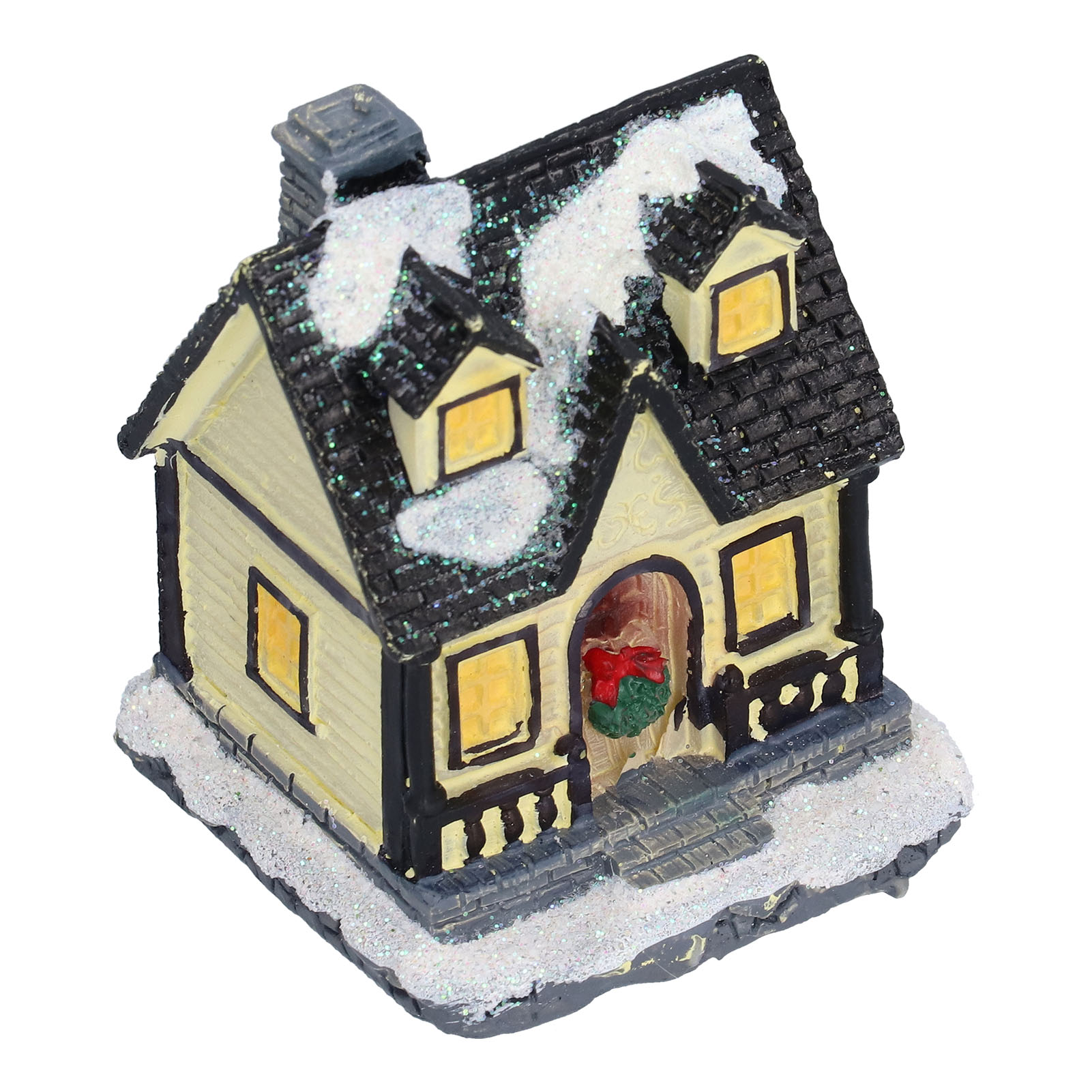 Ein Miniatur-Weihnachtshaus. Es hat ein schwarzes Dach mit Schnee, gelbe Wände und einen roten Schleifenkranz an der Tür.