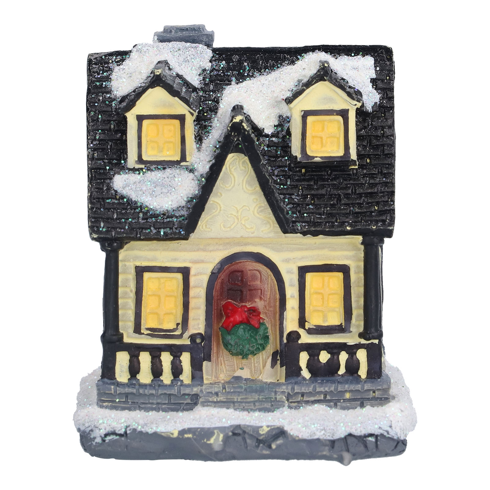 Ein Miniaturhaus mit schwarzem Dach, bedeckt mit Schnee, beleuchteten Fenstern und einer roten Schleife an der Tür, vor weißem Hintergrund.