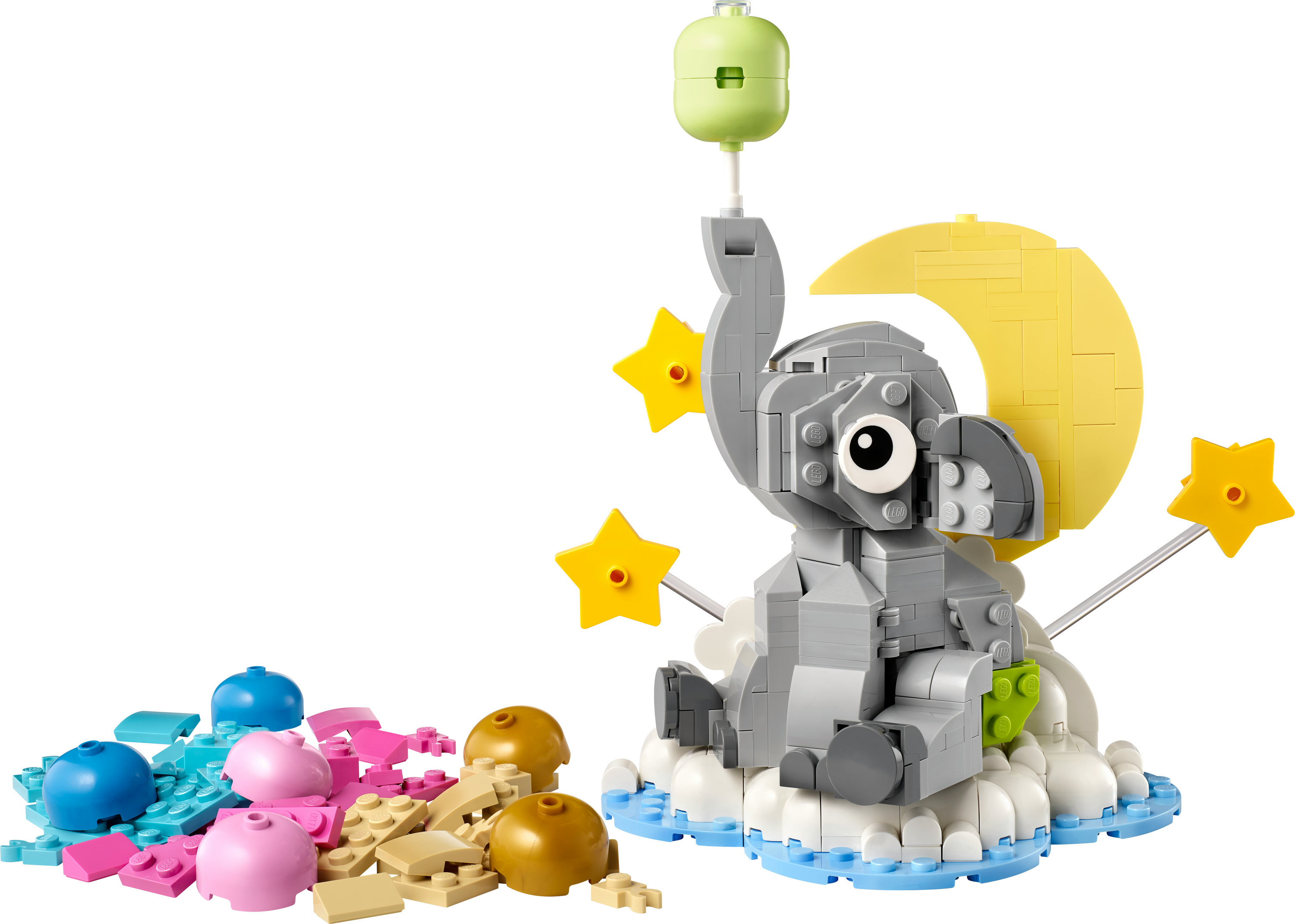Een Lego-olifant op een wolk met een gele maan en sterren. Kleurrijke blokken op de voorgrond.