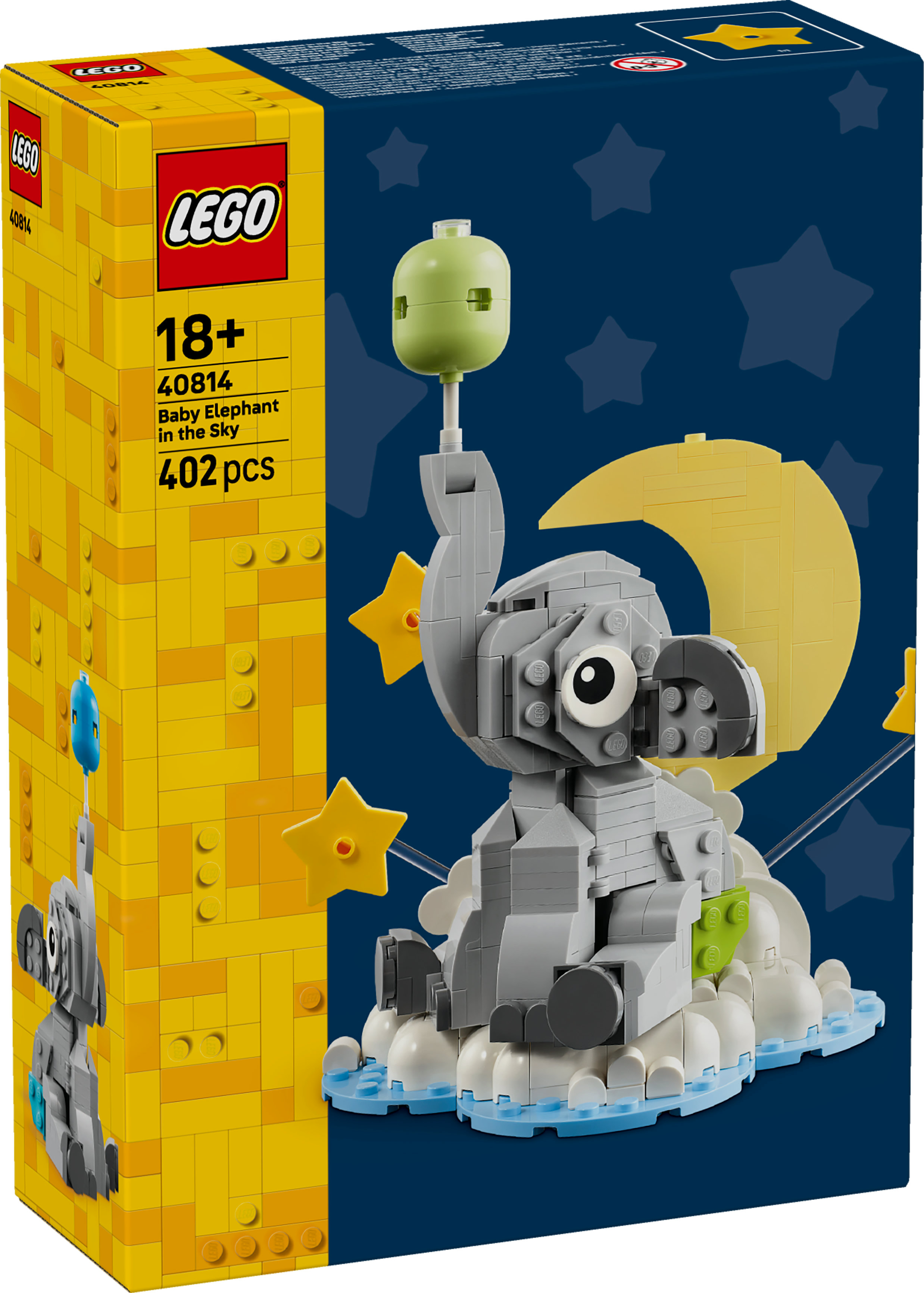 Lego doos met een grijze Lego olifant, een gele maan, sterren en een lichtgroene ballon. De doos is geel en blauw.