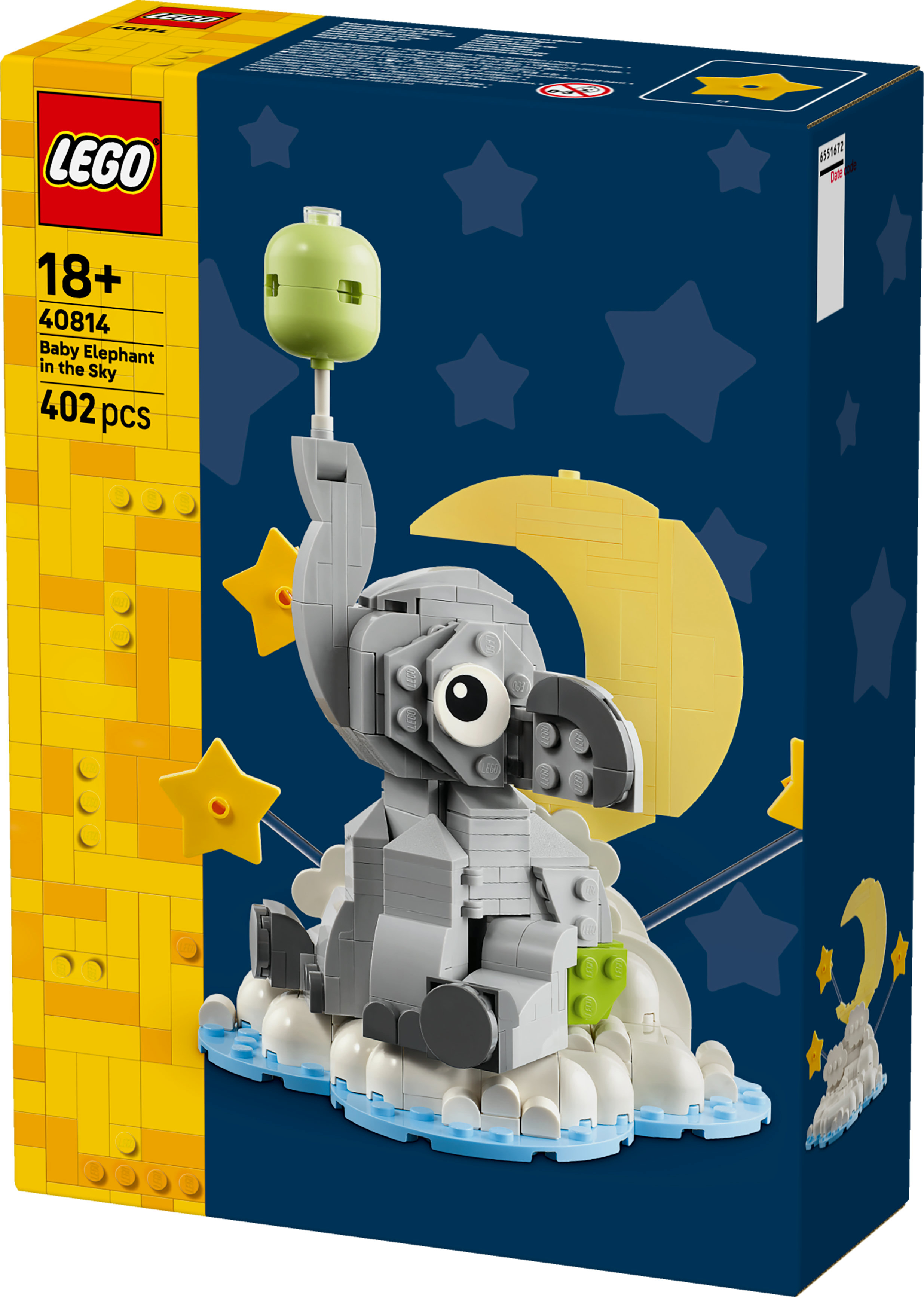 Lego-doos toont een baby-olifant gemaakt van blokken, met een maan, sterren en een groene kop.