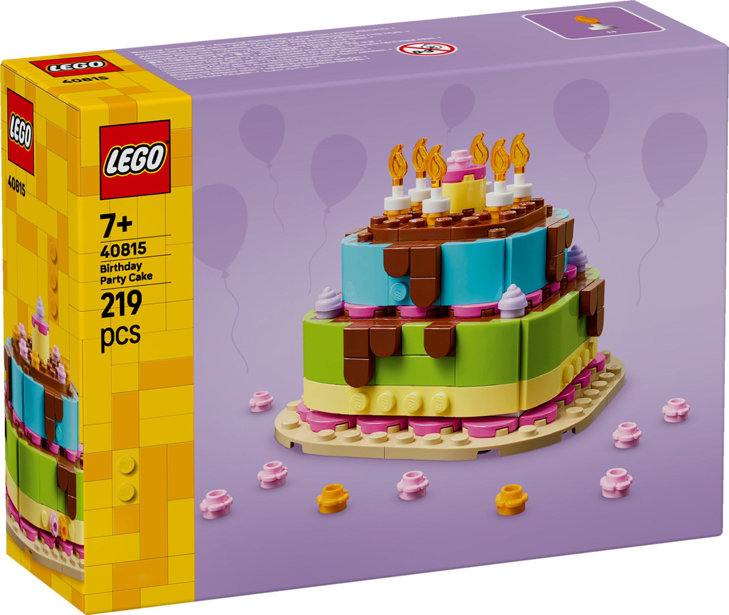 Una scatola di Lego mostra un modello di torta di compleanno. È una torta a più strati con candele e piccole decorazioni sparse.