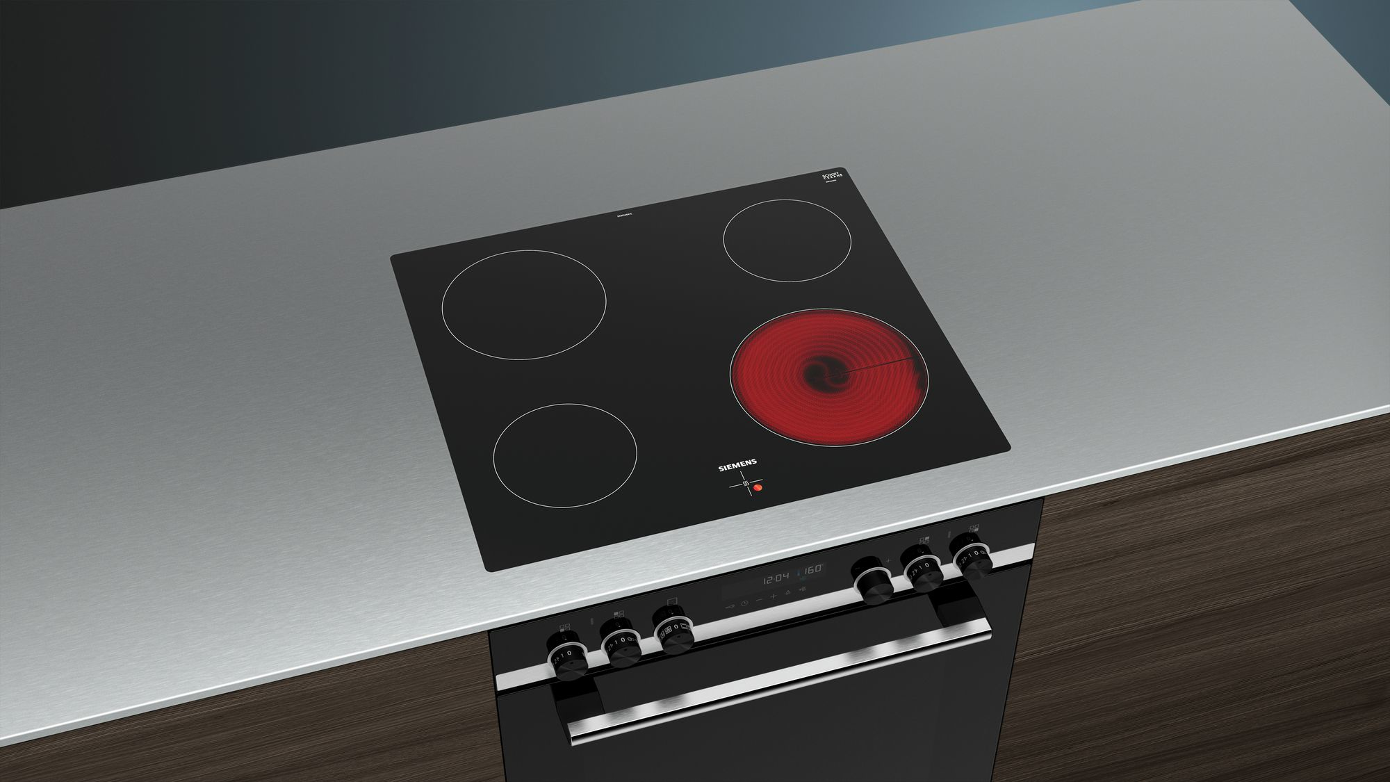 Une table de cuisson électrique noire avec quatre brûleurs, dont un rouge. En dessous, un four avec des boutons et un affichage numérique.