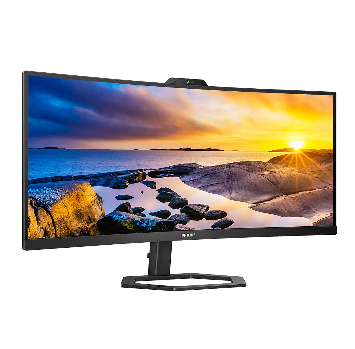 Ein Philips-Monitor zeigt einen Sonnenuntergang über dem Meer mit Felsen im Vordergrund. Der Monitor hat eine Webcam.