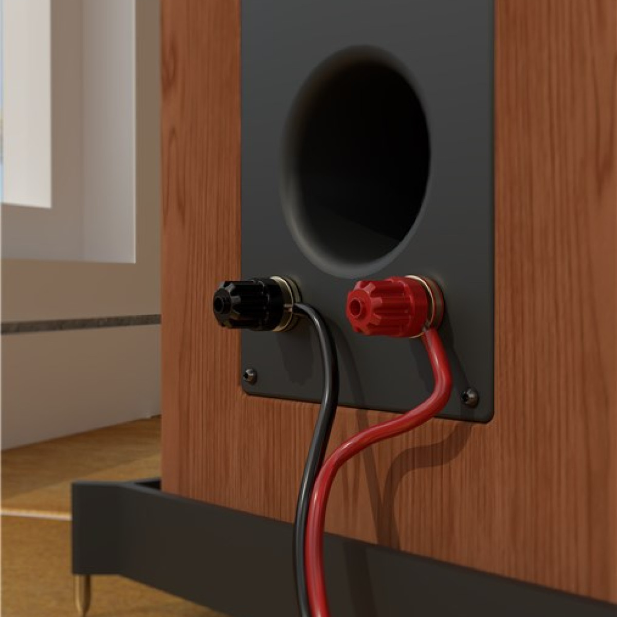 Zbliżenie tyłu głośnika. Czarne i czerwone przewody łączą się z zaciskami. Brązowe drewno i czarny metal z okrągłym otworem.
