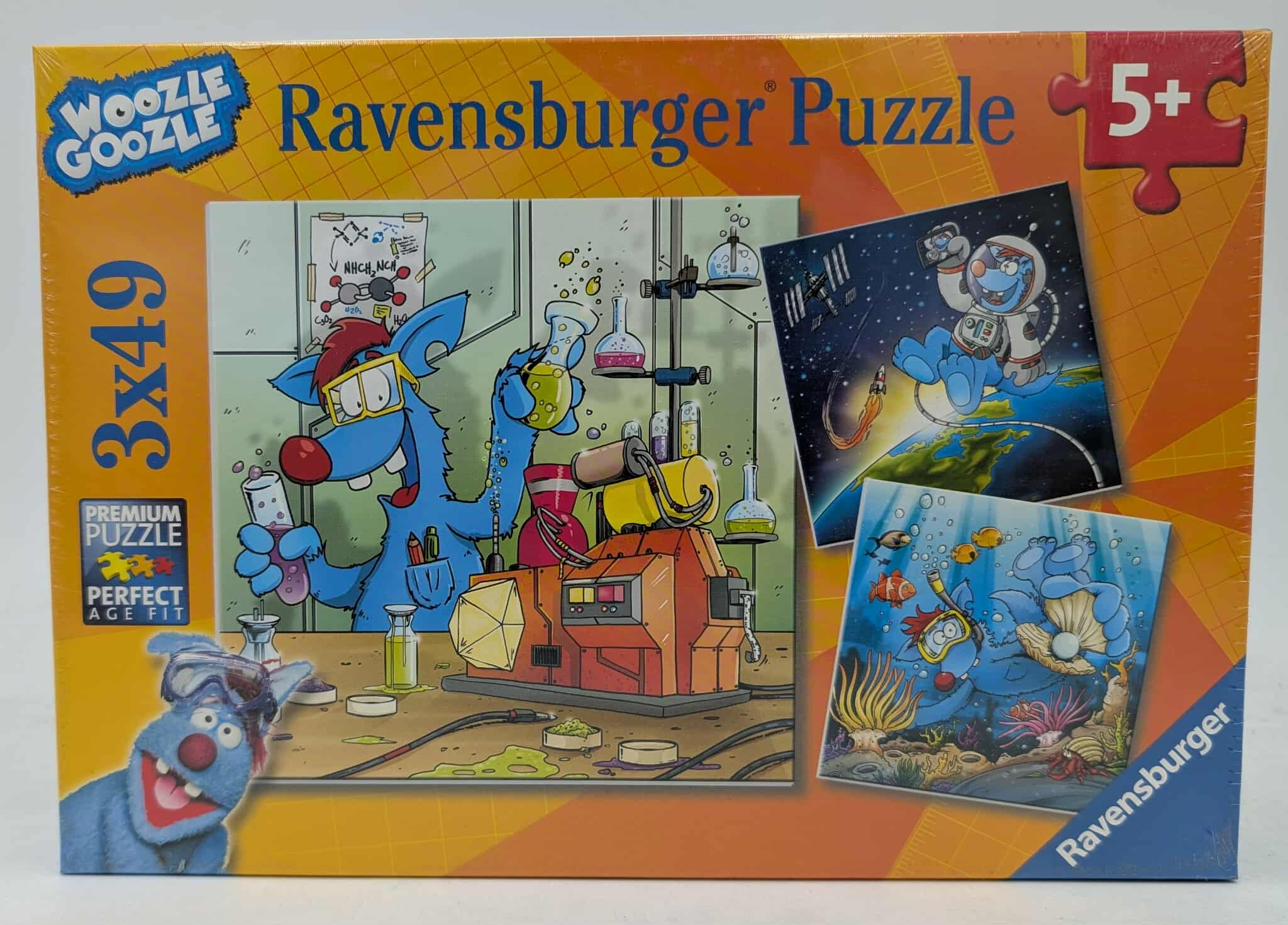 Puzzledose mit blauen Zeichentrickfiguren in Labor-, Weltraum- und Unterwasserszenen, Marke Ravensburger.