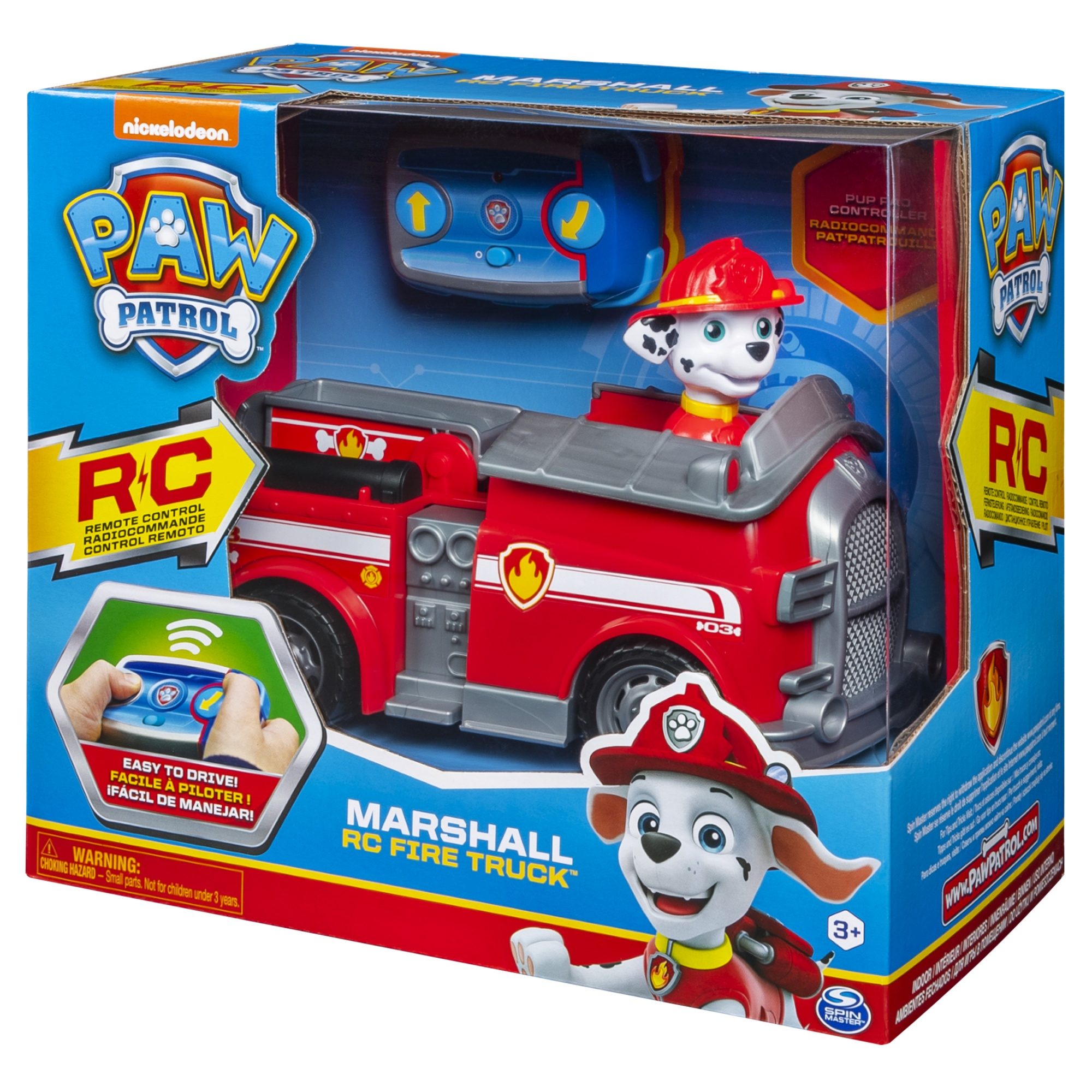 Una caja de juguetes muestra un camión de bomberos rojo Marshall y un control remoto. La caja tiene logotipos de Paw Patrol y una imagen de Marshall.