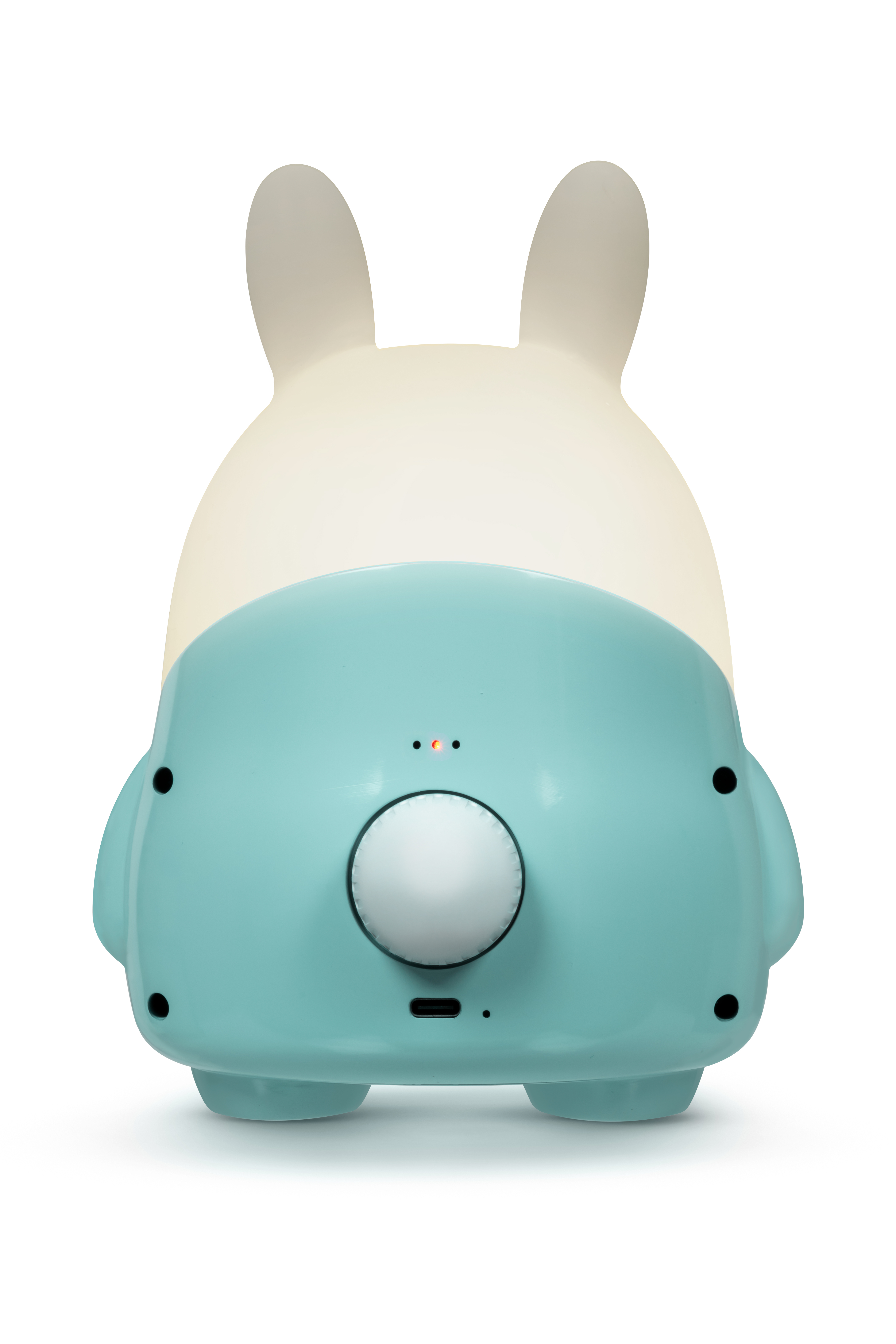 Una luz nocturna con forma de conejo de color verde azulado y crema. Tiene un dial, luces y un puerto USB.