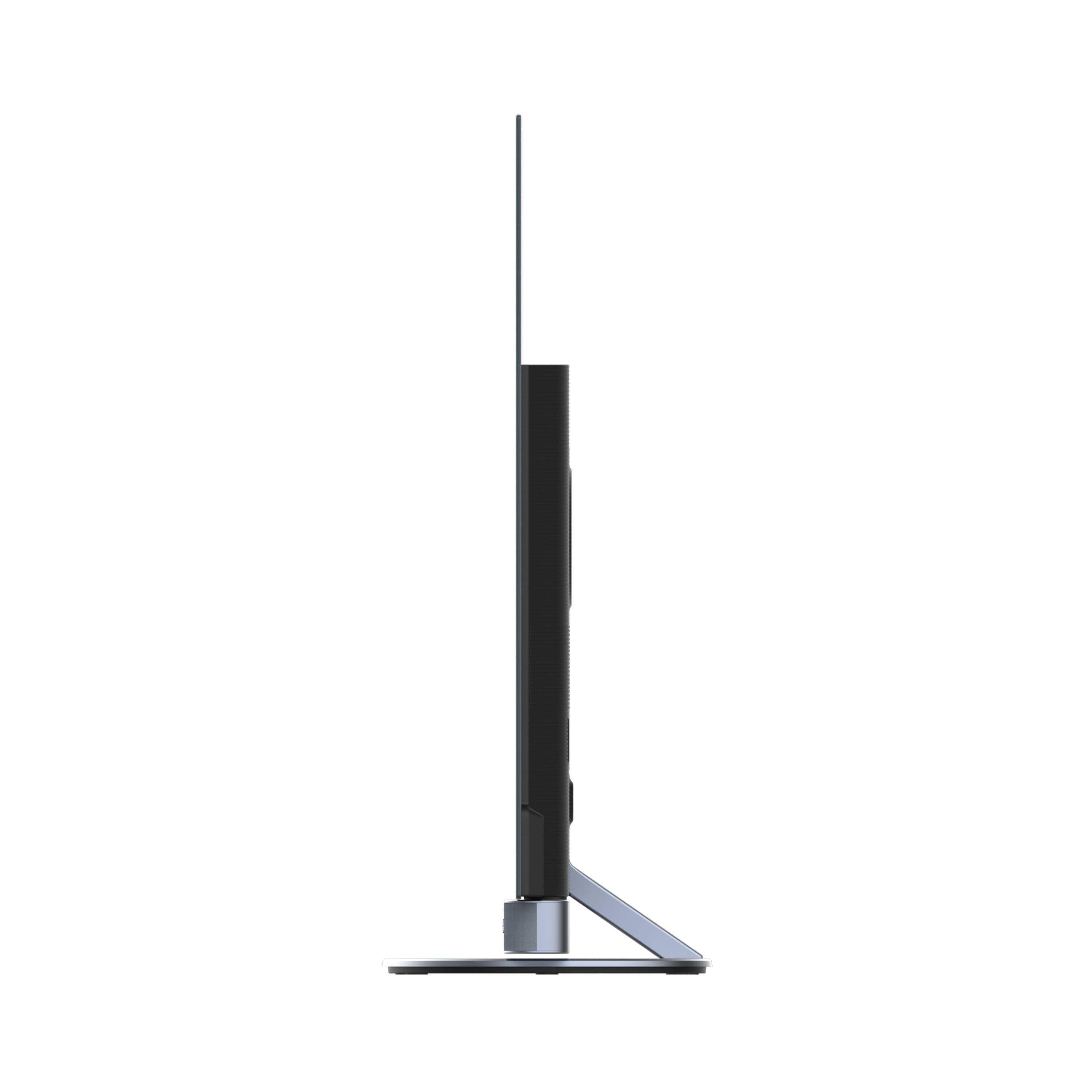 Vista laterale di un'elegante TV a schermo piatto nero. Ha una cornice sottile, un supporto e una base in metallo. Lo sfondo è bianco.