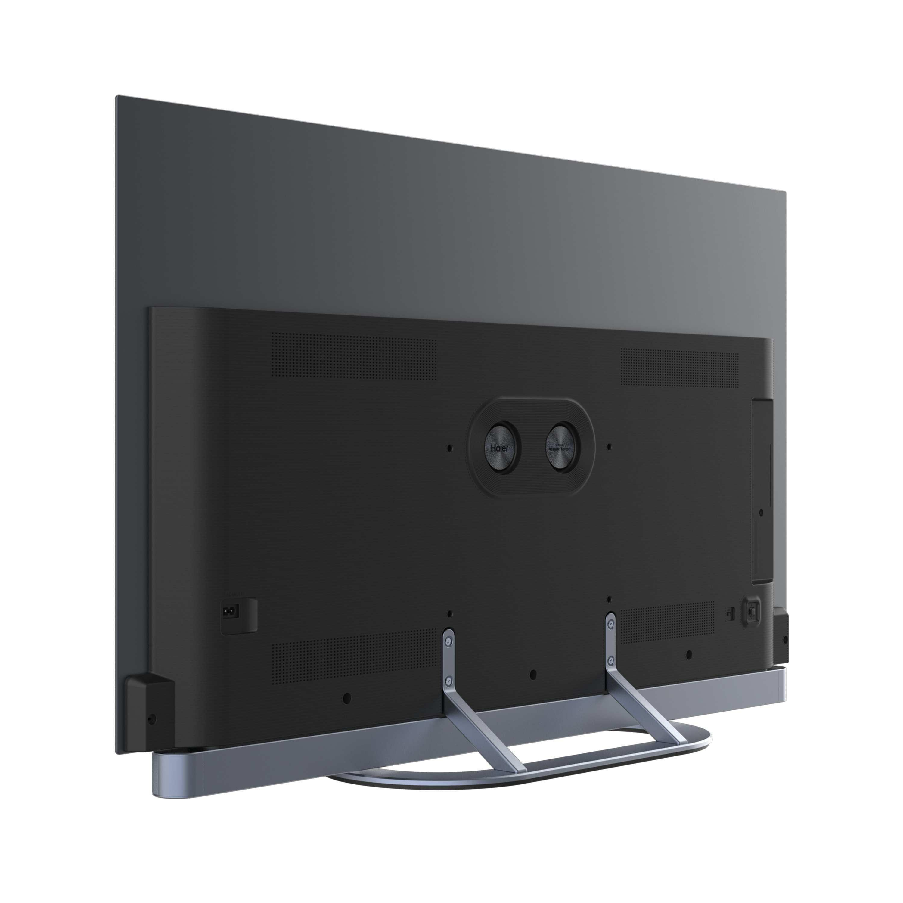 Retro di una TV Haier a schermo piatto, cornice grigio scuro e retro nero. Supporto argentato. Loghi Haier e Harman/Kardon visibili.