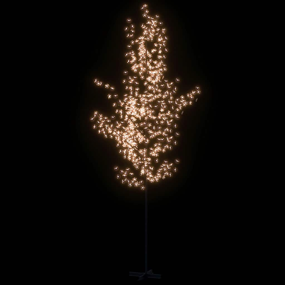 Ein beleuchtetes baumförmiges Objekt vor schwarzem Hintergrund. Die Lichter sind gehäuft und ähneln einem Baum mit Metallständer.
