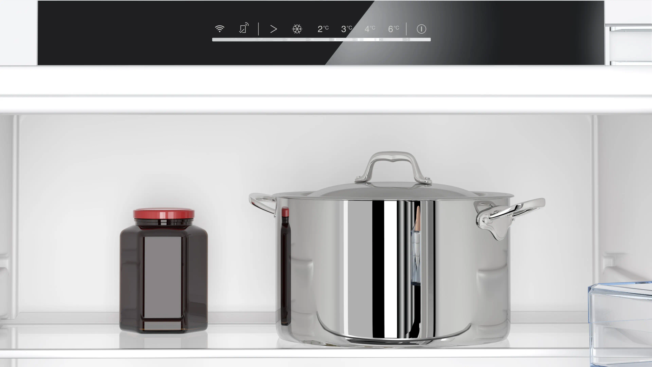 Dentro de la nevera: un frasco, una olla de acero con tapa y un panel de control con temperaturas.