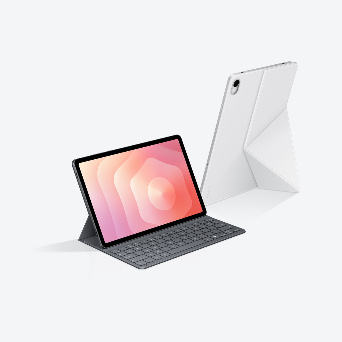 Dwa tablety. Jeden otwarty z klawiaturą, pokazujący kolorowy abstrakcyjny obraz. Drugi biały i złożony, stojący.