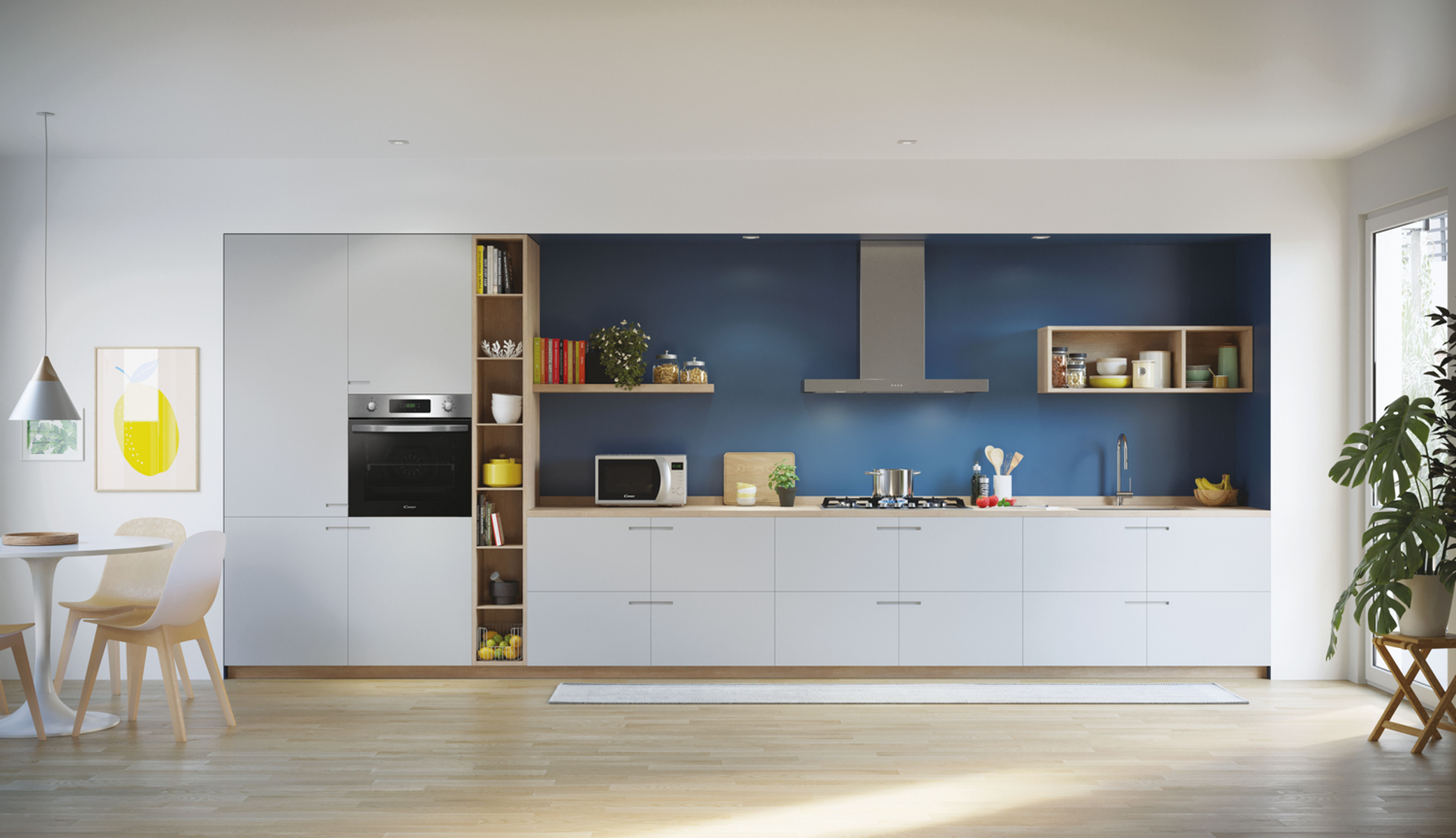 Una cocina moderna con gabinetes blancos, una pared azul, microondas, horno y un comedor con mesa y sillas.