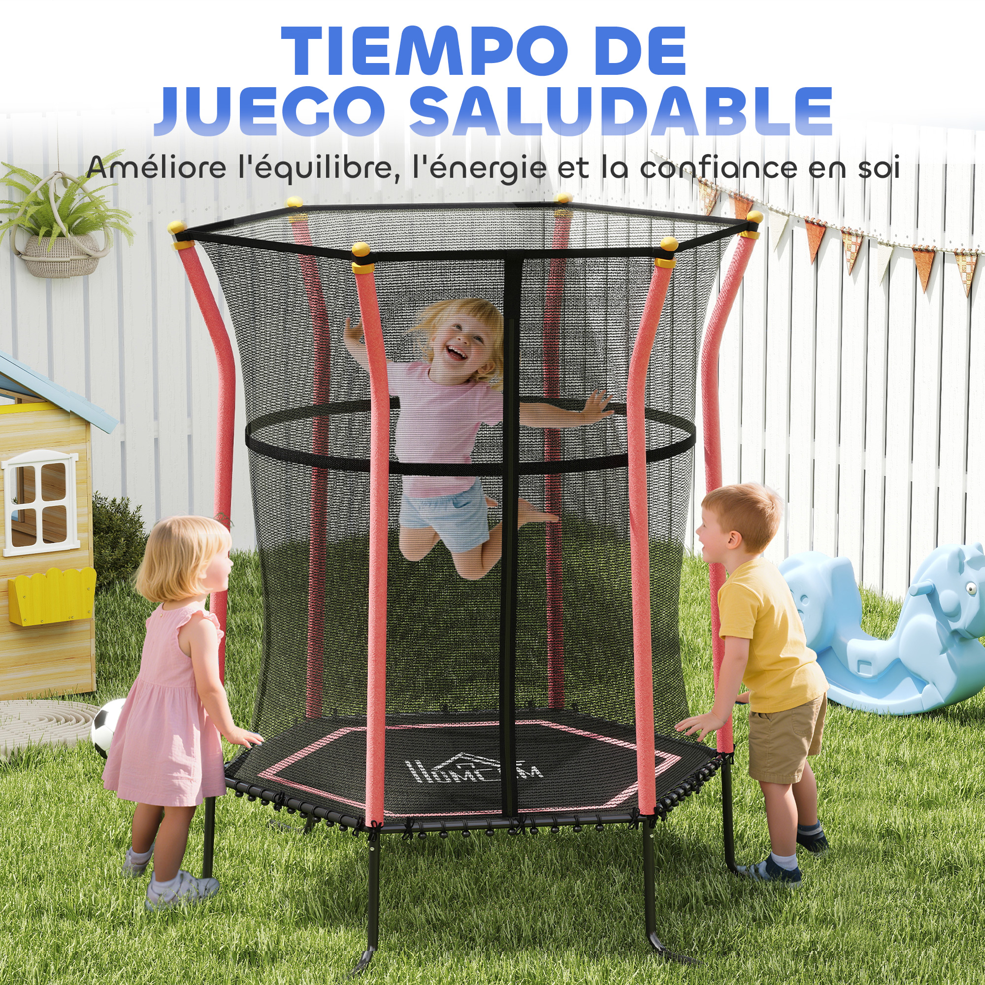 Niños en un trampolín. Un niño salta. Dos están alrededor. Hay una casa de juegos, un balón de fútbol y un caballito balancín azul.