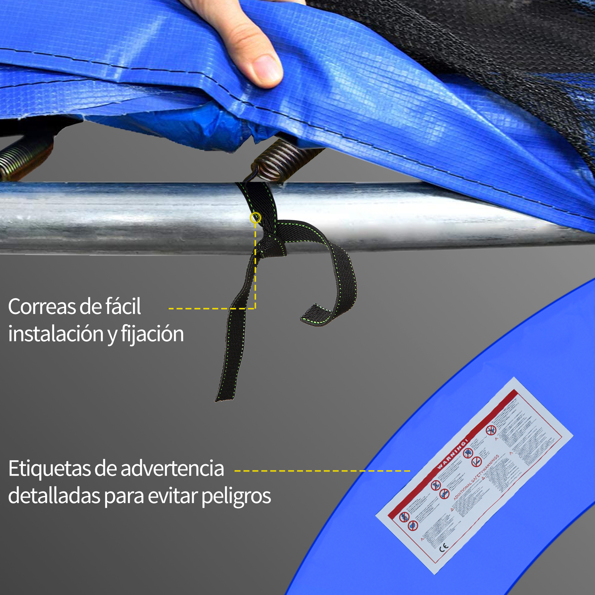 Primer plano de una mano que sujeta una correa negra a un trampolín. También se ve tela azul y una etiqueta de advertencia.