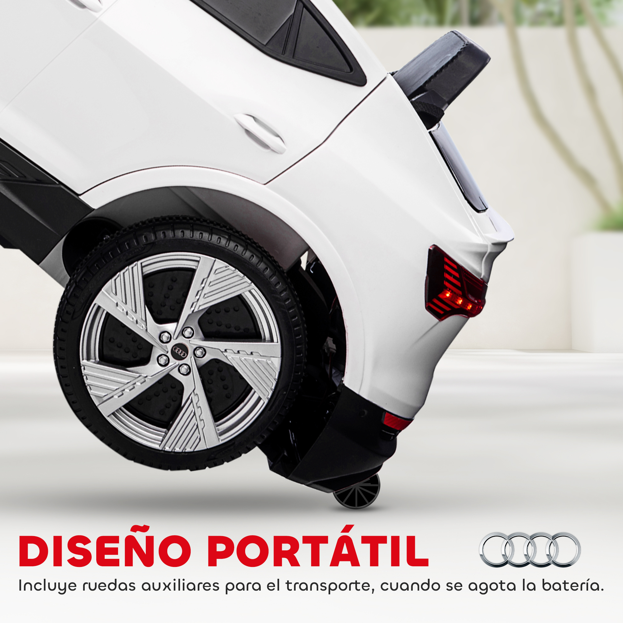 Un coche de juguete blanco con detalles en negro, una rueda grande y luces traseras rojas. El diseño es portátil, con ruedas auxiliares.